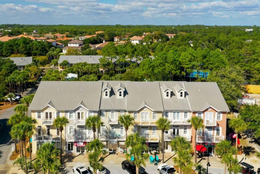 Remarkably close to the beach and Gulf Place attractions, this three-bedroom townhome offers the perfect base for enjoying the best of the beach and family fun within a short stroll. It also includes an income-producing first-floor commercial space, currently Cava and Cakes. Located on two floors above the commercial space, this beautiful unit has timeless hardwood flooring in the living and dining areas and tile flooring in the kitchen. Perch at the breakfast bar for smoothies and snacks while making plans for the day ahead. Take time to admire the newly installed cabinets and sleek granite countertops along with a farm-style sink and new stove. The kitchen and baths also have all-new plumbing fixtures, providing an updated finish. Spread out in the generous living room, which opens