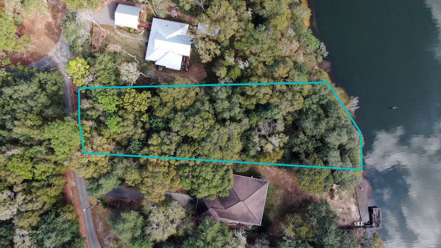 Beautiful Lake Front lot ready for your new home. This lot is over half an acre with beautiful mature trees. City of Defuniak Springs water is available.