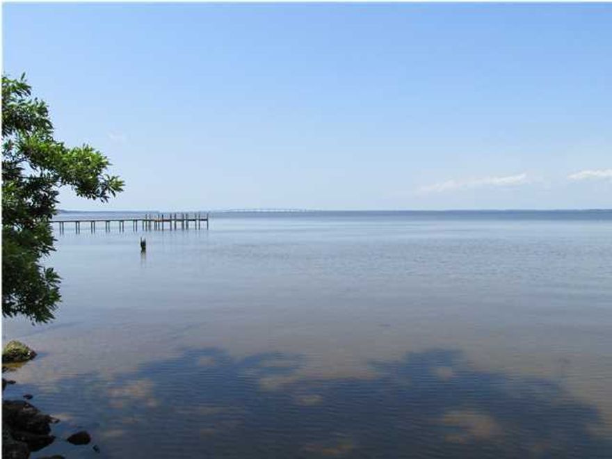 Exceptionally nice 100x300 foot lot on Choctaw Bay with seawall and dock already in place ready for your boat. Road has been paved. . This size and quality of lot is very difficult to find in this area. The lot has beautiful large moss covered oak trees that add to it's beauty Great views including the 331 bridge. No association fees. Road into the lot in place. Property is just north of the beach and Watercolor and Grayton Beach.