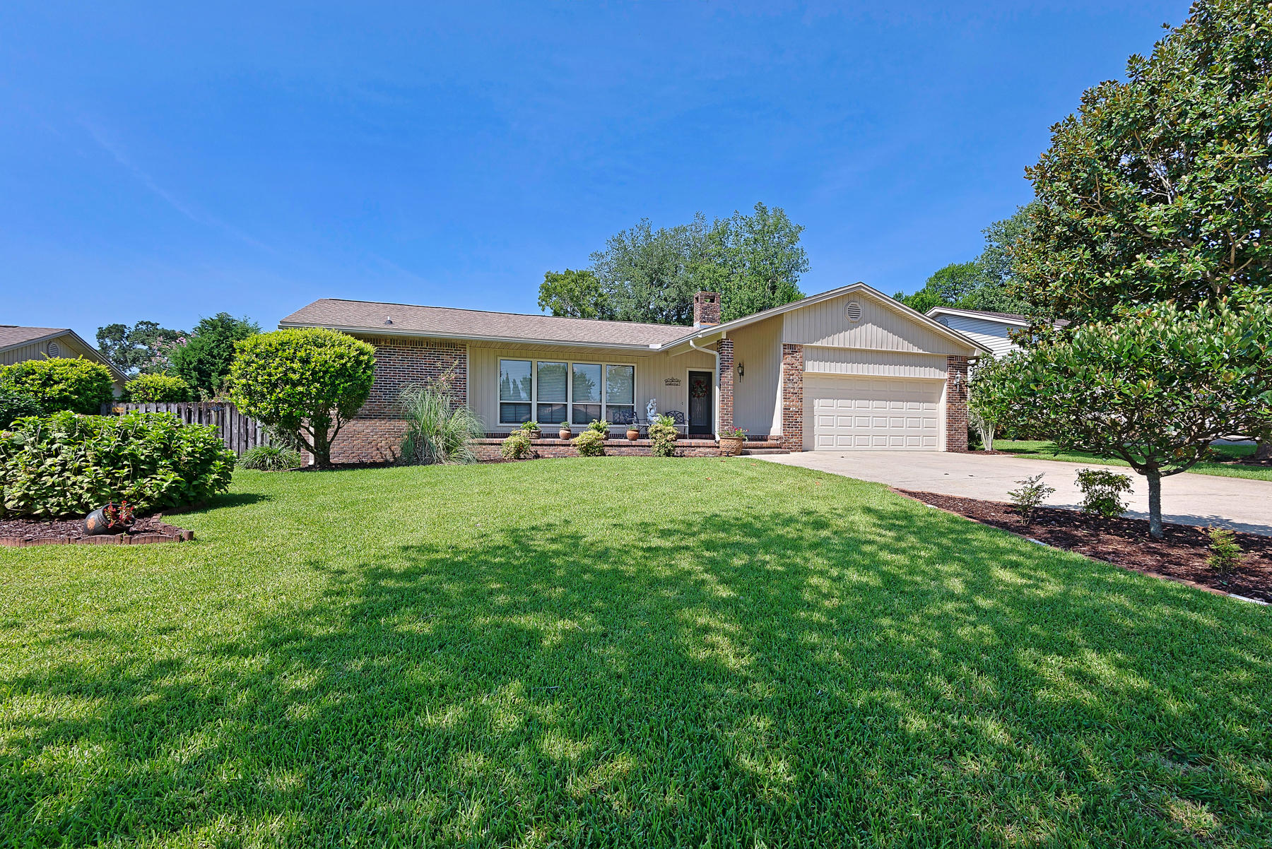You'll make lots of excuses to stay home and enjoy your backyard oasis in this spacious 4 bedroom/ 2 bathroom brick home in the quiet Lake Lorraine neighborhood of Shalimar. There are gorgeously landscaped gardens with the perfect proportion of shade and sunshine, and generous space for entertaining guests. Just when you thought it couldn't get any nicer, the inside features a split-bedroom floor plan with many special amenities including: a wood-burning brick fireplace;low utilities cost; beautiful corian countertops; an eat-in updated kitchen; spacious bedrooms; a living room, dining room and family room with crown molding throughout; and a two car garage.