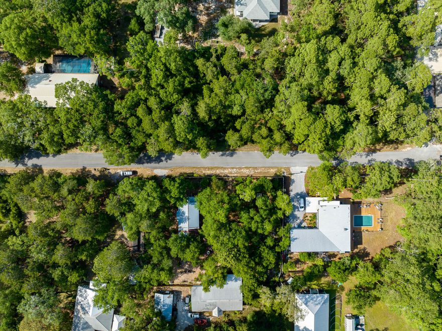 Beautifully, luscious wooded HALF ACRE vacant lot in Point Washington with NO HOA and NO BUILD OUT TIMES! High, dry, & flat! Perfect Homesite in popular and historic Point Washington with easy access to the bay, right around the corner at the public Point Washington Landing and Boat Ramp. 
This sizeable lot allows for ample building opportunities and plenty of room to install a pool.