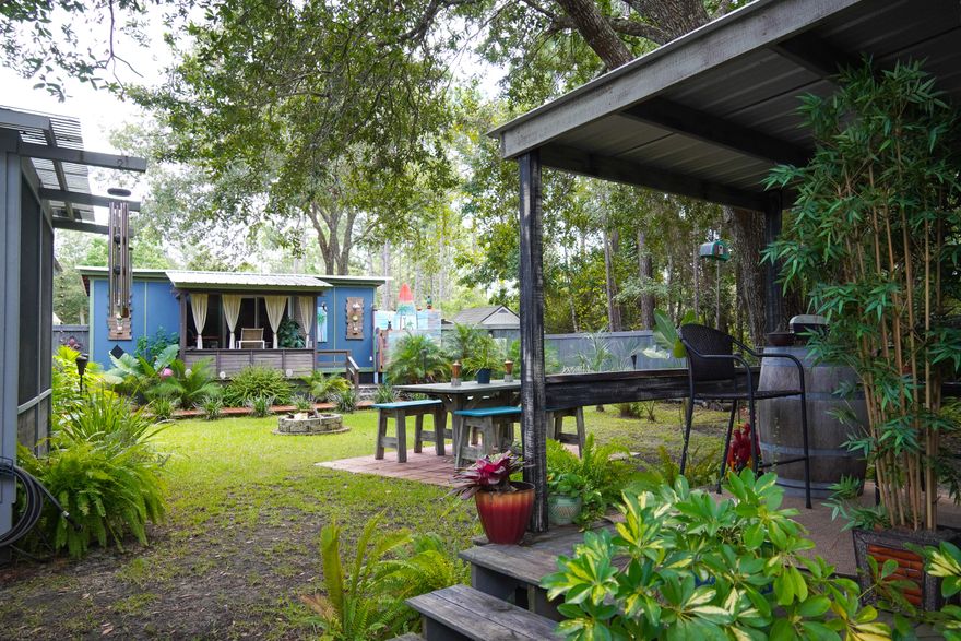 This one of a kind property that consists of  3 beds and  2 bath main house  with an exceptional back porch with built in hot tub. As you enter the backyard  you over look a huge yard  surrounded by and office and guest house. that have been well appointed and designed. The main house has ship lap walls, tile shower, lvp flooring and white shaker cabinets. done with exceptional craftsmanship.The outdoor space outside is a dream for anyone, guest house which can be used for additional income, trailer for a workshop home office and a large oversized carport to park cars and outside work equipment and large enough lot to hold and RV with hook up station.  This house is truly special, seeing it in person you will not want to leave.