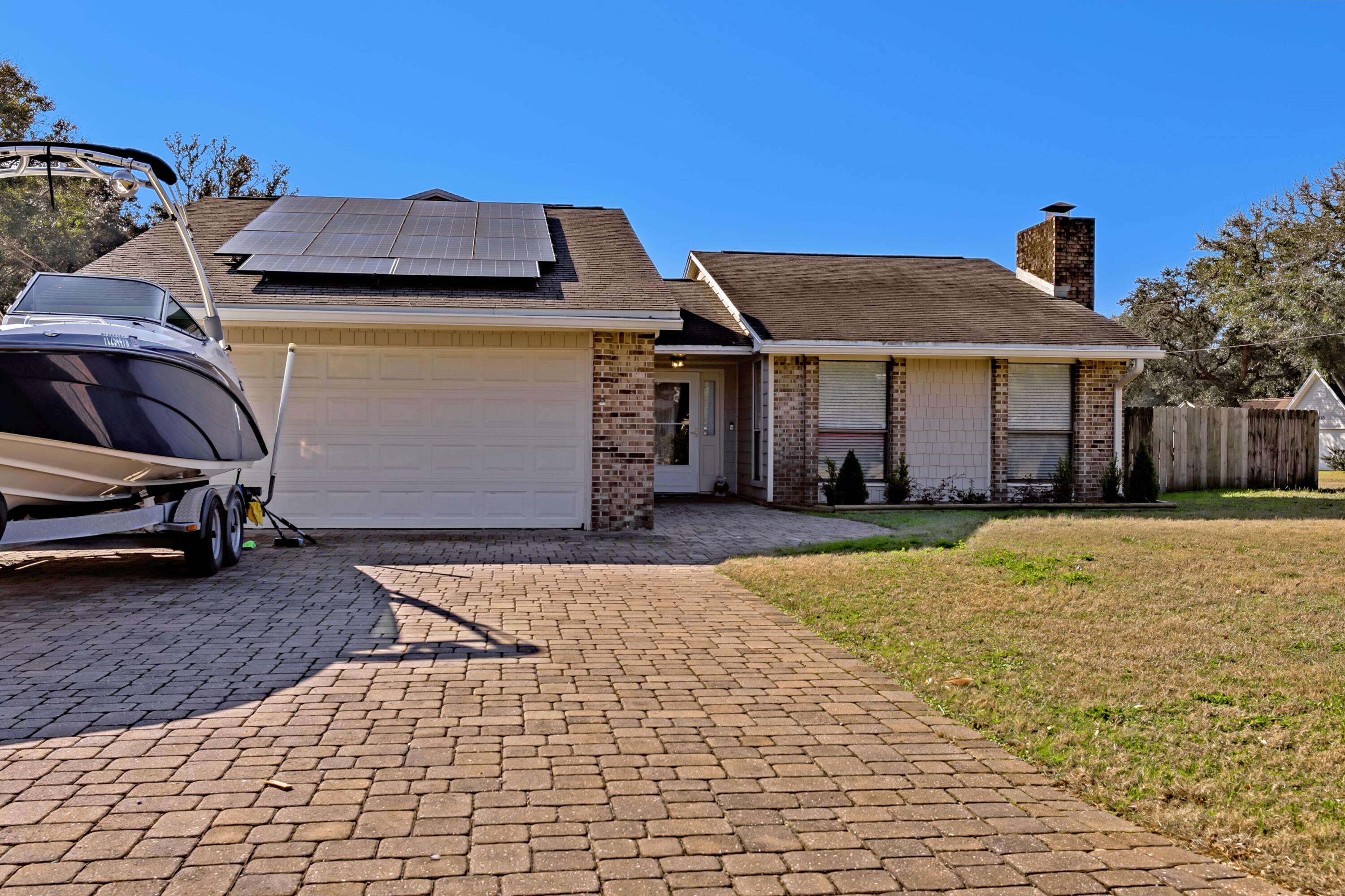 Spacious 5 Bedroom 3 Full Bath home with a 620 Sq foot Master Bedroom & Bath Suite room addition (2015). NO HOA. Open floor plan with a newer Kitchen featuring granite countertops, Stainless Fridge (2021), huge pantry and upscale Legacy Cabinets with slide out drawers & extras. LOW Maintenance Hardie Board plank and brick exterior. Paver Driveway & back Porch pavered. Completely fenced in backyard w/ room for a pool. RV Elec hookup, Gate, and energy efficient Solar Panels (2020). NO Power Bill! With an acceptable offer, Solar panels can be partially paid down & assumed. Convenient location to Eglin Air Force Base, grocery&schools. Smart Locks, Ring doorbell & Sprinkler system. NO CARPET. Neutral tile flooring & wood plank flooring. Top Rated Niceville schools. Won't last long
