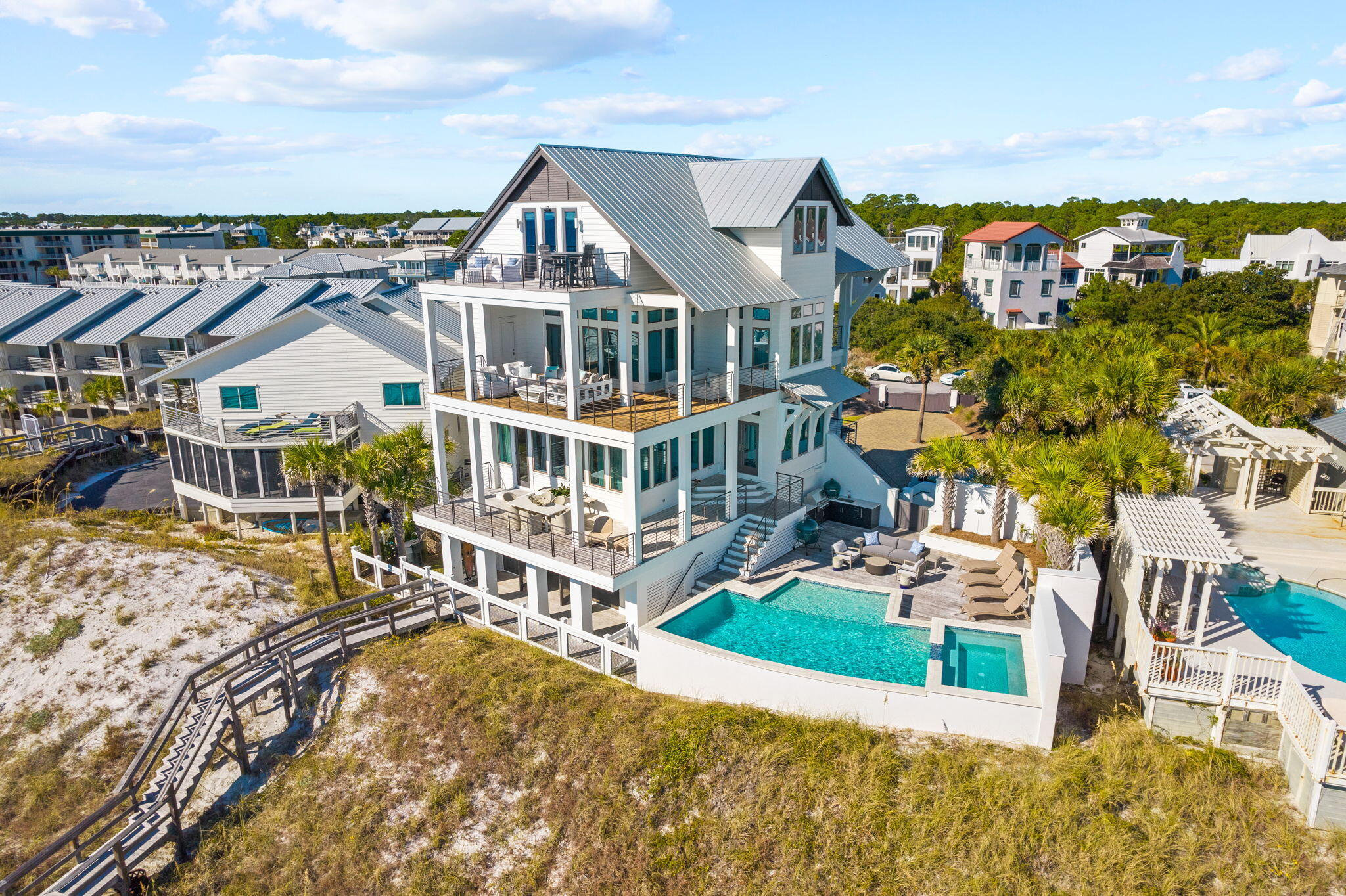 This extraordinary coastal estate, situated on over an acre, boasts 95 feet of Gulf frontage. Renowned Nashville designer Chad James has embodied this residence with an aura of southern opulence and sophistication, while architect Geoff Chick and builder Chris Clark have reimagined this private coastal retreat.Step inside this luxurious estate and experience a seamless fusion of timeless design and unrivaled comfort. The entrance, accessed through a private gate, sets the stage for a truly remarkable experience that also offers endless potential for further development. As you explore the grounds, you'll discover a custom Gulf front pool surrounded by lush thoughtfully designed landscaping, creating a serene oasis.