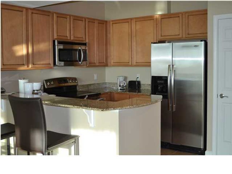 You can have it all at this beautifully furnished 11th floor condo in the heart of Destin! This spacious 2 bedroom 2 bathroom condo is located at The Palms of Destin Resort & Conference Center. Note that the owners have taken the time to redecorate this attractive unit and it does not have original furnishings. To the right of the tiled entryway is the kitchen featuring beautiful granite counters, stainless steel appliances, tile floors, ample cabinet space, a pantry and a bar with stools that's great for entertaining. As you whip a meal, you're able to hear and see everything in the open dining/living area, which features a table for four, a couch, a comfortable leather chaise, carpet, tasteful artwork and flat screen TV. From the living room you can step onto the patio to enjoy the