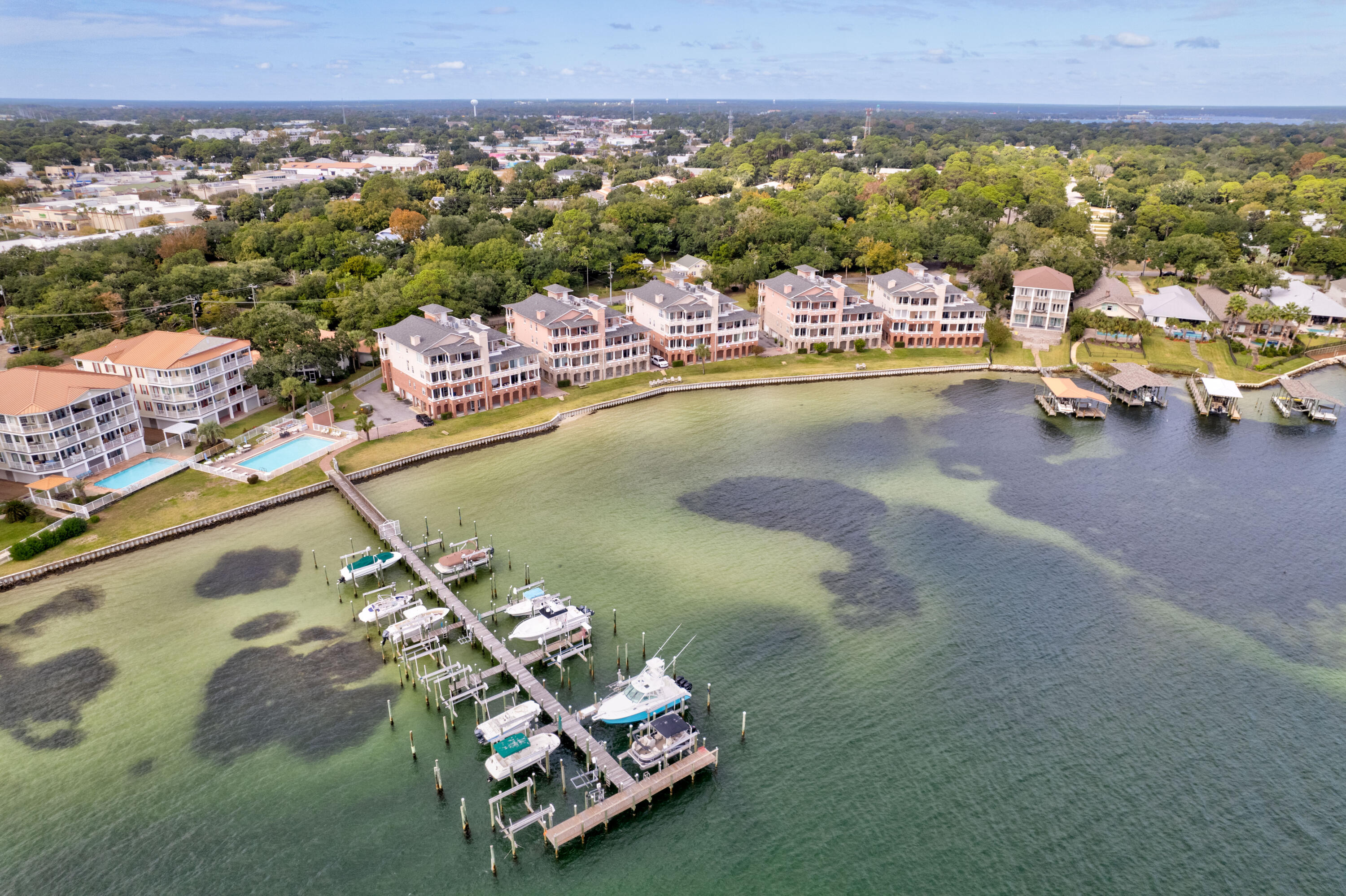 This is a great 2nd floor unit in a 4 story building with boat slip #3 included and excellent views of the Choctawhatchee Bay and the Intercoastal waterway. See the white sandy dunes all the way to the Destin Bridge, watch the fireworks on Wednesday evenings from your balcony between May and September. The gourmet kitchen is only one of the many upgrades. 9 foot ceilings, crown molding, a decorative mosaic Compass tile inlay in the entry, and a balcony off each bedroom. There is a whirlpool garden tub and separate shower in the master suite. There is a private enclosed 2 car private garage & an 11'x11' separate storage unit on the ground floor. The elevator makes for an easy '' lock and leave'' and ''one level'' lifestyle. New hot water heater and Garbage disposal in 2025.