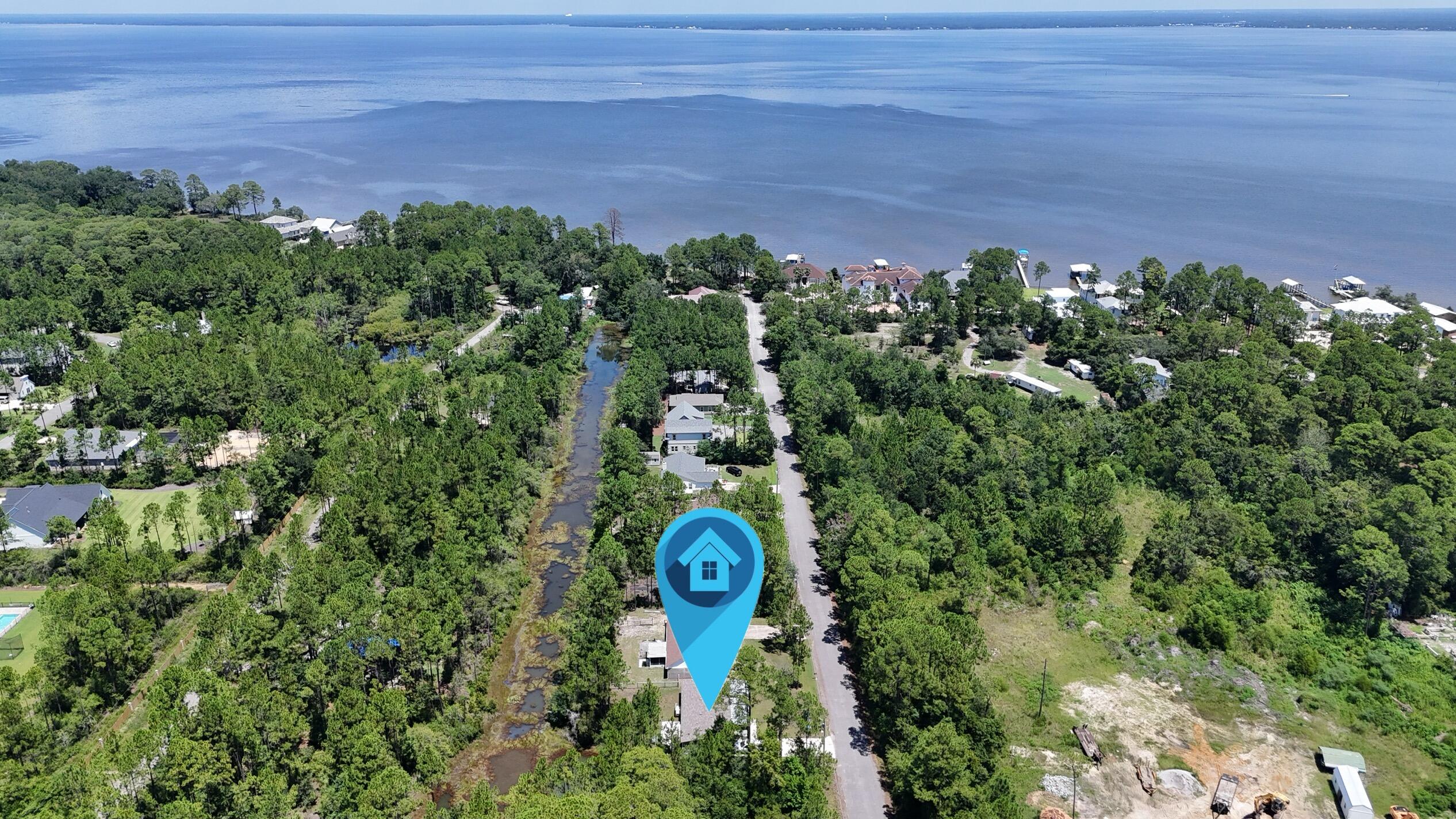 Tucked away in the heart of Santa Rosa Beach, this 4 bedroom, 2 bathroom home offers the perfect mix of comfort, location, and laid-back coastal living. Built in 2022 on a quarter-acre lot, the property backs up to a quiet canal that connects directly to Choctawhatchee Bay -- perfect for kayaking or YOLO boarding straight from your backyard.Inside, the open-concept layout features durable LVP flooring throughout and a spacious, well-kept interior. The large primary suite includes a generous walk-in closet, and all furnishings are negotiable. Out front, the oversized porch is an ideal spot to enjoy your morning coffee or unwind in the evening.Located just minutes from 30A's beautiful beaches, Ed Walline Beach Access, Grand Boulevard, and favorite local restaurants like The Bay, Shunk Gulley, and Stinky's Fish Camp. Publix, parks, boat ramps, and scenic trails are all nearby, offering convenience without sacrificing privacy. This is a rare opportunity to own a well-maintained home in one of Santa Rosa Beach's most accessible and adventure-ready areas.