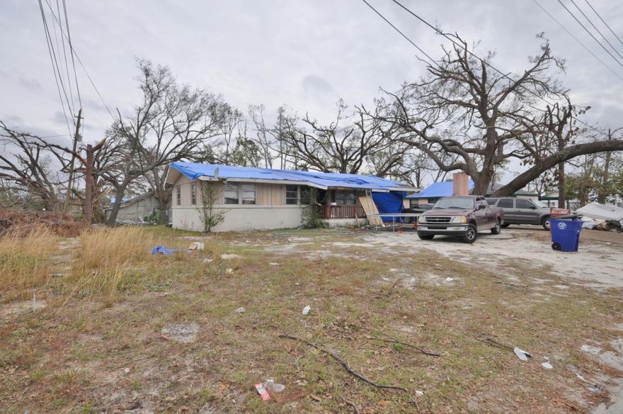 Corner lot with a water view of Watson Bayou. Large 25x20 concrete building in backyard for storage, workshop or garage. Great investment property. Even with Hurricane damage you are getting $795/mo rental income. . All sizes are approximate. Please measure if important.