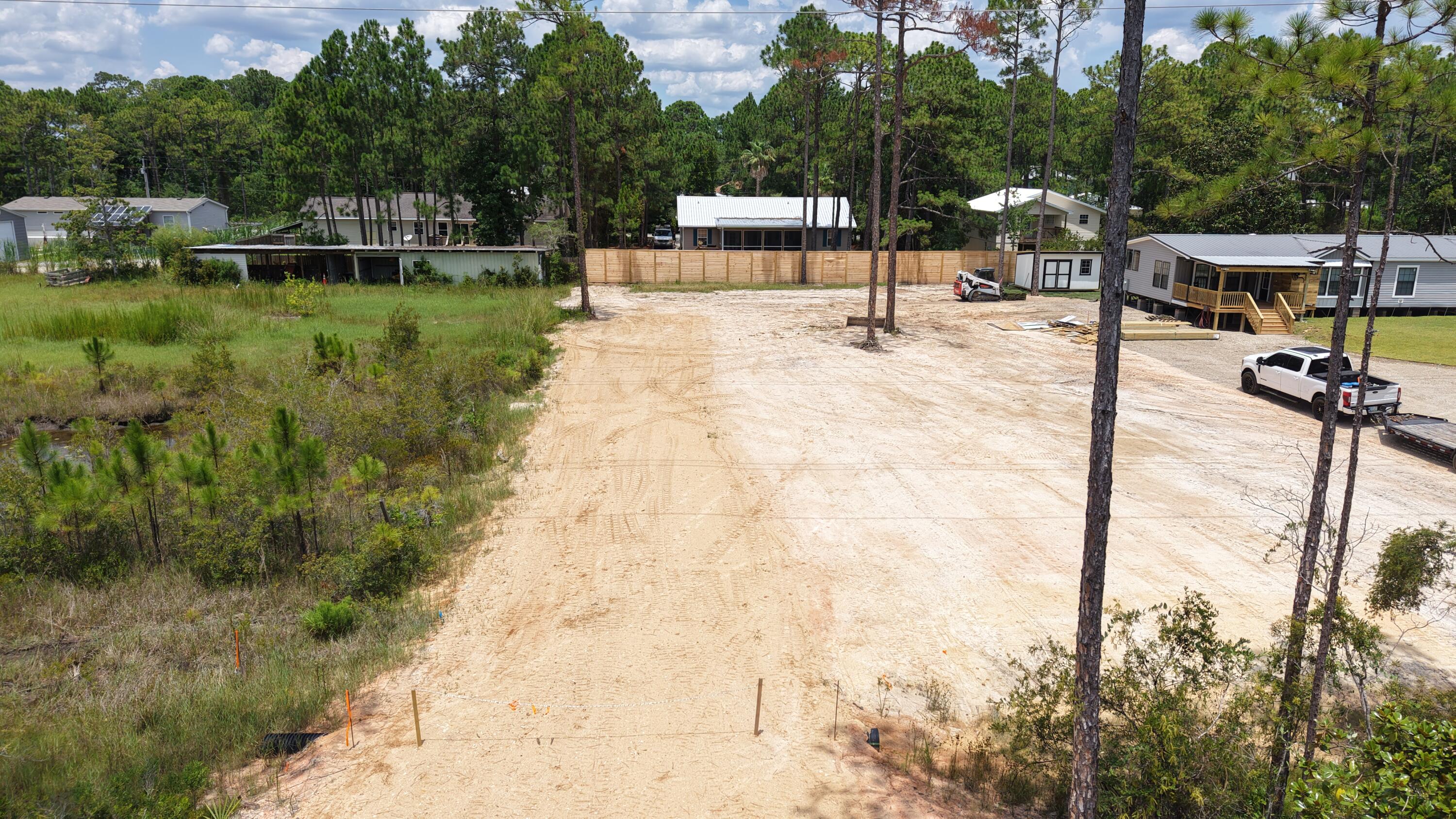 Located just minutes from the beaches of 30A and all the shops, restaurants, and conveniences of Grand Boulevard, this cleared lot is prepped and ready for your dream home. Whether you're looking to build a primary residence, second home, or investment property, this spot offers the best of both worlds. Tucked away from the hustle, but close to everything.