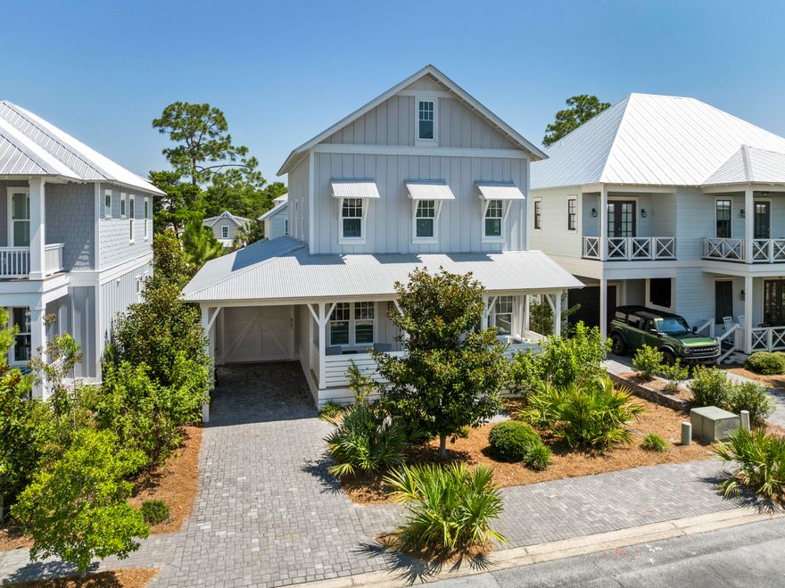 This beautifully designed home offers thoughtfully planned spaces, perfect for full-time living, a second home, or rental and includes a 6 seater golf cart. Enjoy designer finishes throughout--shiplap walls, hardwood floors, 10' ceilings, designer lighting, & a coastal palette with wallpaper accents. Main level features an open-concept living/dining area with surround sound, a gourmet kitchen with quartz island, 6-burner KitchenAid range, & filtered water system, plus a primary suite with dual closets & ensuite bath. Second level offers a second primary suite, two guest rooms, shared bath, & laundry. On the third floor: spacious media/bunk room with full bath. Relax on the oversized front porch or dine on the private paver patio. Boutique community  amenities include pool, clubhouse.... access to Redfish Village, shopping, dining, and nearby beach access.