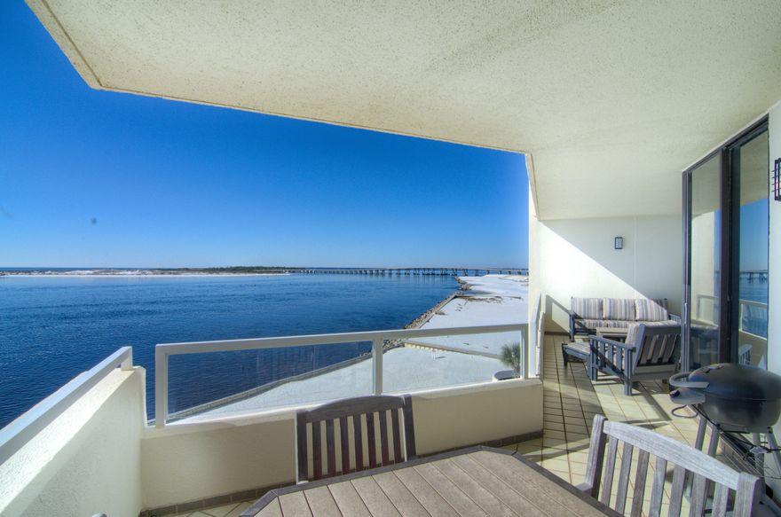 The STUNNING views of the emerald green waters from the Gulf of Mexico to Destin's East Pass are breathtaking! Every room of this exquisitely renovated condo is spacious and has an open floor plan with two living areas, along with floor to ceiling windows in every room to maximize the amazing water views. This is one of the few Martinique floorplans, which rarely come on the market. The gorgeous, well equipped kitchen will please any chef. The additional wet bar with wine cooler in the large dining area adds to your ease of entertaining. The storage space is amazing with a large utility room with extra fridge. Tile throughout. Both balconies can be accessed from every room in this condo to enjoy ''the best seat in the house'' to watch the boats, fireworks and emerald green waters.