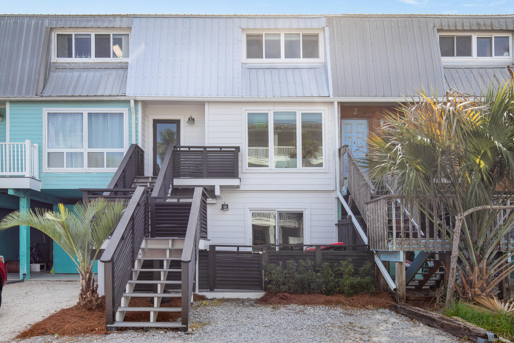 Grayton Beach is quite possibly one of the most eclectic and sought after areas on all of 30a! Where else can you get a beach permit and drive on the beach!? This gorgeous townhome is literally a stone's throw away from red bar and the beach. Recently renovated with new metal roofing, hardie board siding, newly landscaped BACK YARD, all new trex porches, white painted soft close cabinets/drawers, stainless steel appliances, lighting fixtures, granite counters, all bathroom tiling with master rain head shower, square edged cottage trim throughout with tongue and groove accents, engineered hardwood flooring, high impact windows/doors, and plenty more! This townhome has been meticulously maintained and current owner never short term rented! Come buy your diamond in the sand!