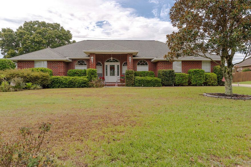 Come and revel in the breathtaking aesthetics of this staycation-worthy backyard oasis, where a solar-heated, in-ground 48x18 saltwater pool takes center stage amidst a lush tapestry of tropical landscaping.  Tucked away in a cozy pocket of the secure gated community in Cottonwood, this 3-bedroom, 2-bathroom, 2166 SF home is ideally located near Berryhill Rd, providing convenient access to Pace and Milto.  A few steps inside the grand entrance, the grand foyer gives way into a vast great room with soaring vaulted ceilings, gleaming hardwood floors, artful plant ledges, a snug fireplace, and double French doors that beckon you to the screen-enclosed porch and the inviting pool beyond.  To the right, you'll discover a versatile home office, (or with the right touch, a fourth bedroom).