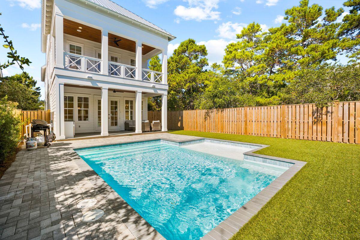 Completed in 2021, this pristine beach house south of 30A is available fully furnished and turnkey. It's just the place to enjoy family vacations and memory-making year after year. Designed in a traditional southern style, it boasts full-width porches front and rear and a covered poolside terrace for socializing, entertaining and having fun. A paved driveway and garage provide ample parking and storage for bicycles and beach toys. The interior benefits from lofty ceilings and gleaming hardwood floors complemented by quartz countertops and stainless steel appliances in the impressive gourmet kitchen. It has everything you need to create meals for hungry hordes after a day at the beach.