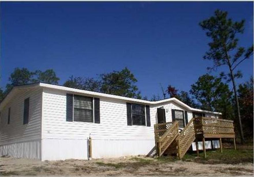 Cute home in Holt. FURNISHED! Peaceful setting on 1 acre. With a large metal building perfect for garage use or a workshop. Home is in good shape. Split floor plan, nice size kitchen and laundry room. Deck on both the front and back of the home. Buyer to verify all information deemed important. Home is being sold As Is