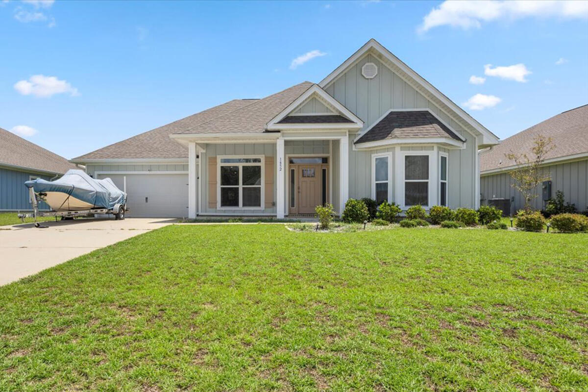 || NOW PRICED BELOW MARKET VALUE || Welcome to 1452 Ballyhoo Drive, an exceptional home in Gulf Breeze, Florida. This property is located steps from the water, but with no flood insurance required (flood zone X). This residence features 5 bedrooms plus an office/bonus room, a wide-open floor plan, and an assumable VA loan at an incredibly low rate. With low HOA fees, this home offers unparalleled value. The expansive family room with double tray ceilings creates a welcoming atmosphere, while the well-designed kitchen includes an oversized island, separate dining area, walk-in pantry, granite countertops, and ample cabinet storage. The primary bedroom offers a luxurious en suite bath with double vanities, a garden soaking tub, shower, private restroom, and walk-in closet. Enjoy outdoor living in the fenced backyard with a spacious covered patio, perfect for a pool, garden, or entertainment space. Additional features include luxury vinyl plank flooring, impact-rated fabric hurricane window and door shutters, and a Smart Home Connect system with a video doorbell, keyless entry, and multiple security cameras. The neighborhood is family-oriented and provides easy access to the Gulf Breeze Zoo, the upcoming new Soundside High School, and I-10. The property includes new fencing and gutters, hurricane shutters, and a survey on file. Don't miss out on this incredible opportunity in a serene and convenient location!