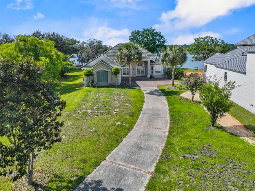 STUNNING 4 bed/3 bath executive POOL home with expansive views of LaGrange Bayou! Breathtaking retreat in the gated community of LaGrange Cove. This home screams Florida with 141' of waterfront. With its waterfront views, private dock, boat lift, pool & hot tub overlooking the water and a 27'X10' covered lanai with gas hookups for an outdoor kitchen, this home is perfect for relaxing on the water. Built along the intra-coastal waterway this home is a boater's dream with its proximity to one of 3 fueling facilities on the bay. Inside you will find 2600sqft with 10' and 12' ceilings capped off with crown molding, custom transom windows throughout and almost every room in the house has views of the water. Schedule your private showing today to appreciate the Florida lifestyle this home offers As you enter the home from the double front doors you are welcomed by the sight of the bayou across the open floor plan.  In the living room you will find a large fireplace, setting the tone for hosting gatherings for friends and family. The kitchen comes with everything you need, 5 burner stove, Thermador oven, pantry, granite counters, breakfast bar and tons of storage in the custom maple cabinets. The sizeable master suite opens to the lanai and overlooks the bayou and pool while the two guest rooms and bathroom, on the other side of the house, can be separated from the house by closing a pocket door to give a sense of privacy. The house also features an alarm system, oversized 2 car garage, whole house generator, hurricane shutters and temporary RV connection. This is a fantastic opportunity to own a piece of boater's paradise.