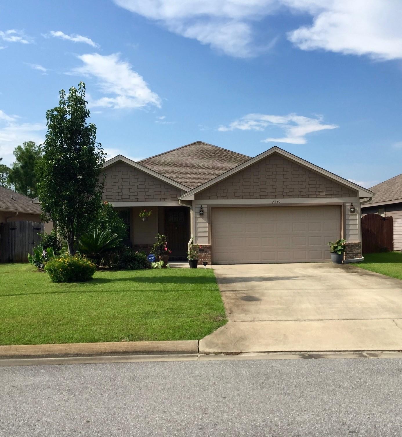 Centrally located in Navarre, less than 15 minutes to Hurlburt Field & 5 minutes to beaches. This 3 bedroom 2 bath former model home has an open floor plan with 10 ft. ceilings & double hung windows for spacious naturally lit rooms that view the forest. Upgrades include beautiful brazilian hardwood floors, granite countertops, recessed lighting throughout, custom bookshelves with built in window seat in front spare bedroom, and built in surround sound in living room. Master bedroom has a walk in closet, granite double-vanity in private bath, box-trey ceiling and own access to back yard. Kitchen includes 35 sq ft of counter space, custom cabinets, walk-in pantry, stainless steel appliances, as well as breakfast bar. Fenced backyard is landscaped to enjoy Florida blooms year-round from paved back patio with cafe lighting wired into the custom-built pergola and grape arbor. Neighborhood has underground utilities.
Additional Features: finished garage, two-piece crown molding in living room, spanish- lace ceiling, stained fiberglass entry door, 30yr high definition dimensional shingles, termite and fire resistant Hardie Plank siding and soffits with brick accents on the front, sprinkler system, well and timer.