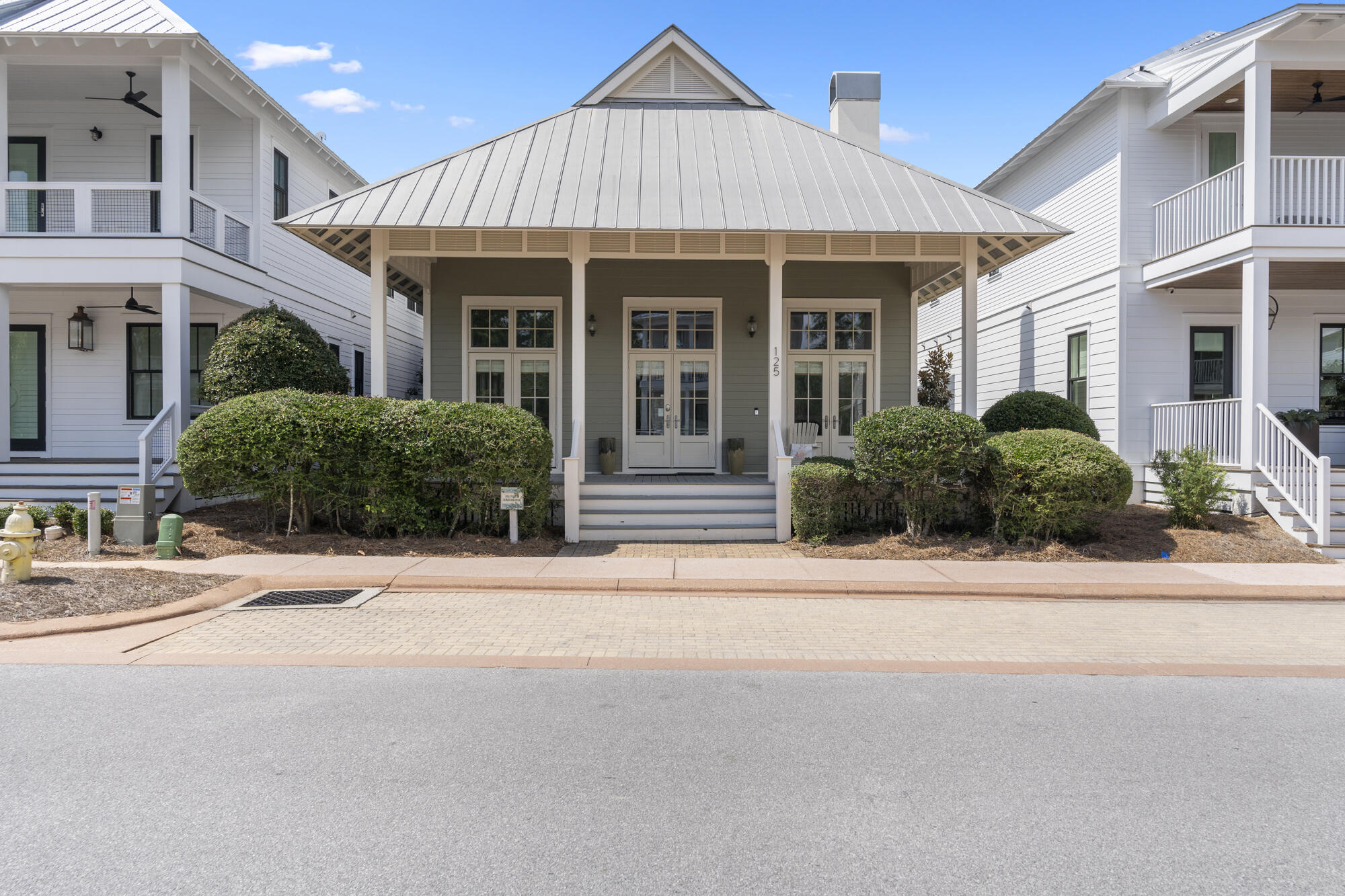 Welcome to this fully furnished, turnkey property, located in the beautiful Cypress Dunes community on 30A's west end. This pristine 4BR/3.5BA home is ideal as a full-time residence, vacation home, or rental property. Every detail has been meticulously crafted, featuring standout finishes such as heart pine wide plank floors, white shaker cabinetry, a freestanding tub, and designer lighting. The inviting open living area boasts vaulted ceilings, a fireplace, and custom bookshelves, while the fully equipped kitchen includes stainless steel appliances and a gas range. Enjoy the Gulf breeze from the spacious front porch or relax on the rear screened-in porch overlooking serene green space.