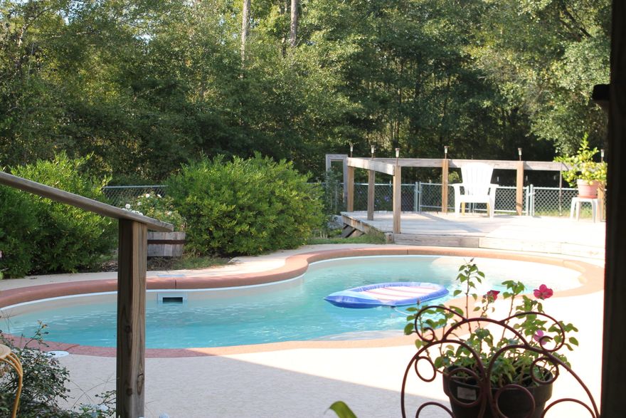 Total brick home on 1+ acre in the BAKER SCHool district. Open floor plan. Split bedroom plan. Breakfast bar. Many upgrades include: Tile in kitchen & bath, marble vanity tops & around tubs. Dimentional shingles on roof. In ground pool with a fenced back yard and deck! Beautiful flowers around the pool! Also, a shed and a workshop for all your projects! Sit on the front porch shaded by the giant oak tree. Hurry, Hurry, or you will miss out!