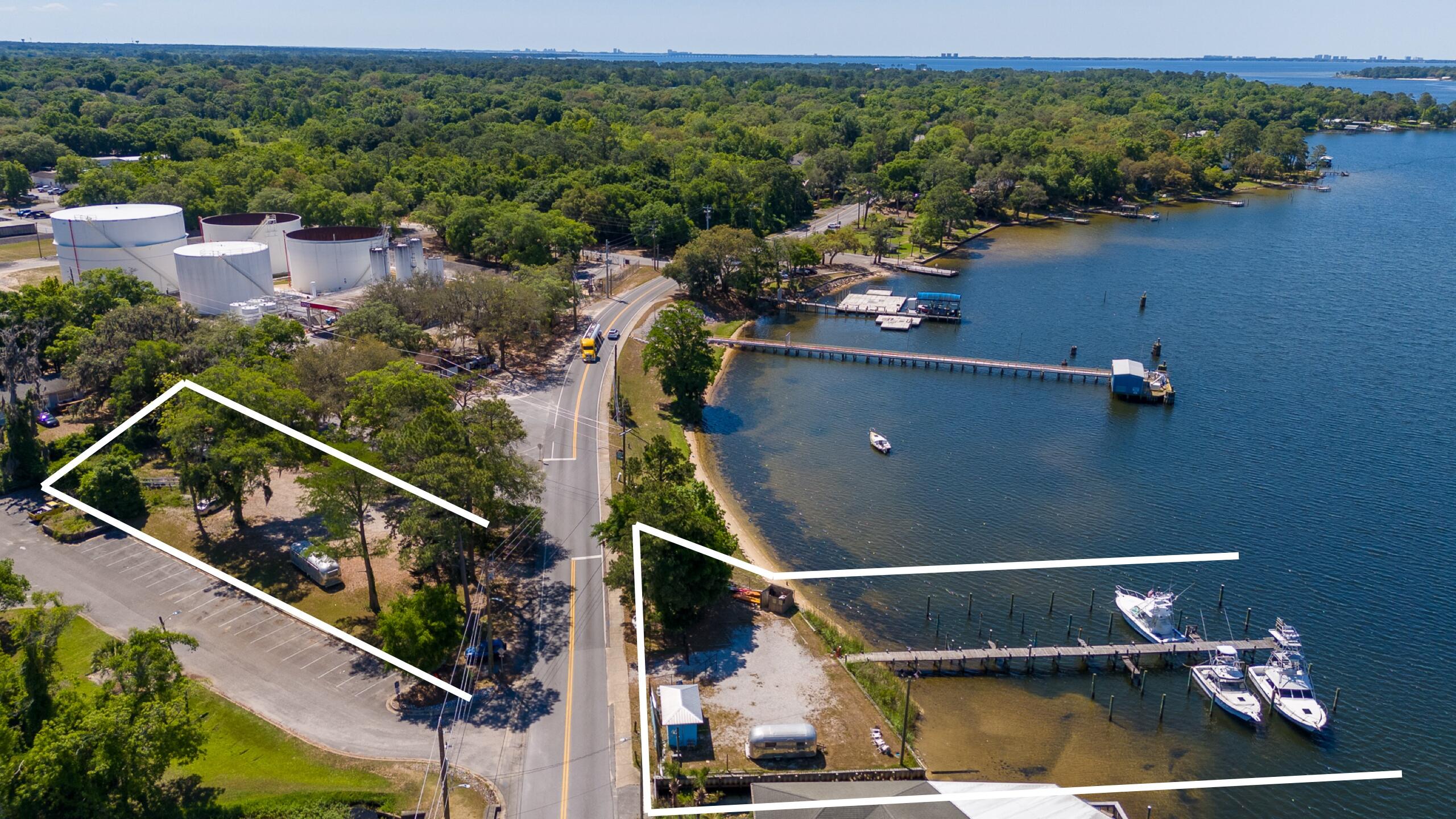 This is an excellent opportunity to own one of the last waterfront parcels featuring a 10-slip marina 75 ft on Boggy Bayou, located next to the Wharf 850 in Niceville, Florida. The property consists of two parcels totaling 0.81 acres with commercial zoning, offering a variety of possibilities includes parking lot (buyers to verify marina expansion options). It's just a short 20-minute boat ride to the Destin Pass. The boat slips range in size from 14 to 16 feet wide with a depth of 4 to 5 feet, up to 18 feet wide with a depth of 8 to 10 feet. The last four slips can accommodate 50-foot sport fishing boats, and the end of the dock is approximately 10 feet deep. Additionally, the property includes a 2000 31-foot Cabo Express fishing boat, valued at $119,000 according to Boat Trader The boat is equipped with 3116 Caterpillar engines, updated electronics, a new AC tower, and outriggers. Electronics on board include a plotter, depth machine, radar, and autopilot, all from Simrad.