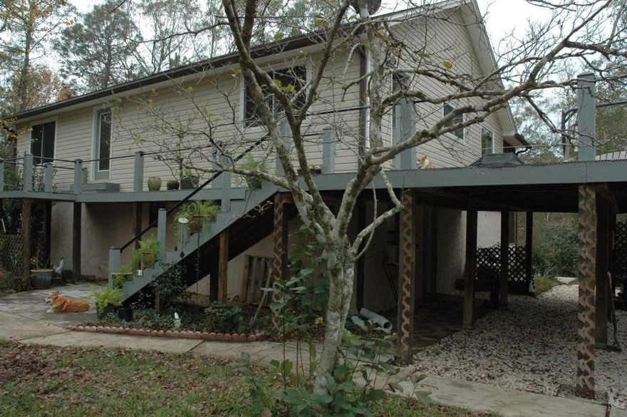 Looking for some privacy and acreage away from noisy neighbors, yet still within 6 miles from town, grocery stores, restaurants and schools? Then this creek front unique property is the perfect location for you! Located on just under two acres, this country setting offers an outdoor paradise for kids and adults alike. Private, white sand, clear creek for cooling off in the hot summer months. Outdoor features - fire pits, secure fenced area for pets, 4 covered carport spaces double gates for boat/RV parking, fruit trees, treed areas for target practice, archery, wildlife watching, zoned for horses, the list goes on and on.