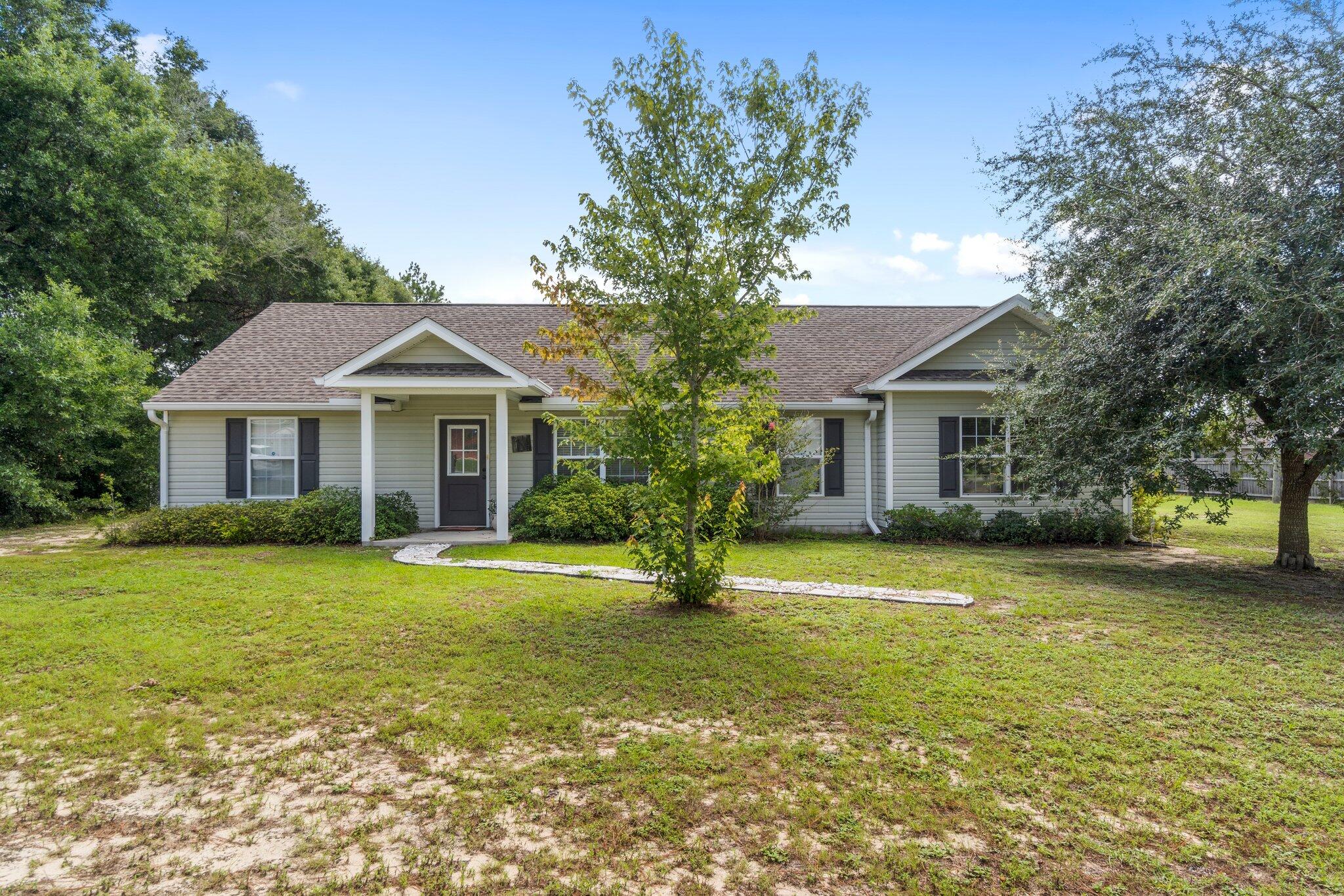 *With acceptable offer, use seller concessions to buy down interest rate!Appraised OVER asking price! Come see this beautiful home on the North side of town that sits on a full acre of land. This home features a combination of wood and tile flooring, with no carpet! The high ceilings provide a cozy environment for entertaining or relaxing. The kitchen and dining areas are very deliberate while still maintaining an open concept feel. The spacious owner's suite features an on suite bathroom with a large double vanity. The back yard has an oversized deck with a covered, screened in patio. In addition to a carport, there is a 3 bay detached garage with power and additional covered outdoor space.