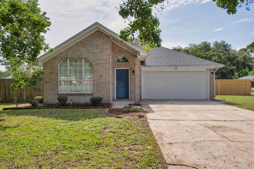 ROOF 2021! VA Assumable Loan at 3.125%! Welcome home to this charming 3-bedroom, 2-bathroom home offering 1,395 square feet of well-planned living space. Located just minutes from Hurlburt Field, this Mary Esther gem sits on a spacious lot with a large fenced yard, a new gate, and a storage shed--perfect for outdoor living, pets, or extra storage. Inside, vaulted ceilings greet you in the main living area, where you'll find a cozy fireplace and durable laminate flooring throughout the home. The kitchen features granite countertops, a tile backsplash, and tile flooring--both stylish and easy to maintain. The master bedroom includes a walk-in closet and direct access to the screened-in back porch (your own private spot to relax at the end of the day). Two additional bedrooms and a second full bathroom offer space for guests or a home office. A two-car garage gives you room for parking and storage. This home blends comfort, space, and convenience all in a location close to base, beaches, and local shopping. Move-in ready and full of charm!