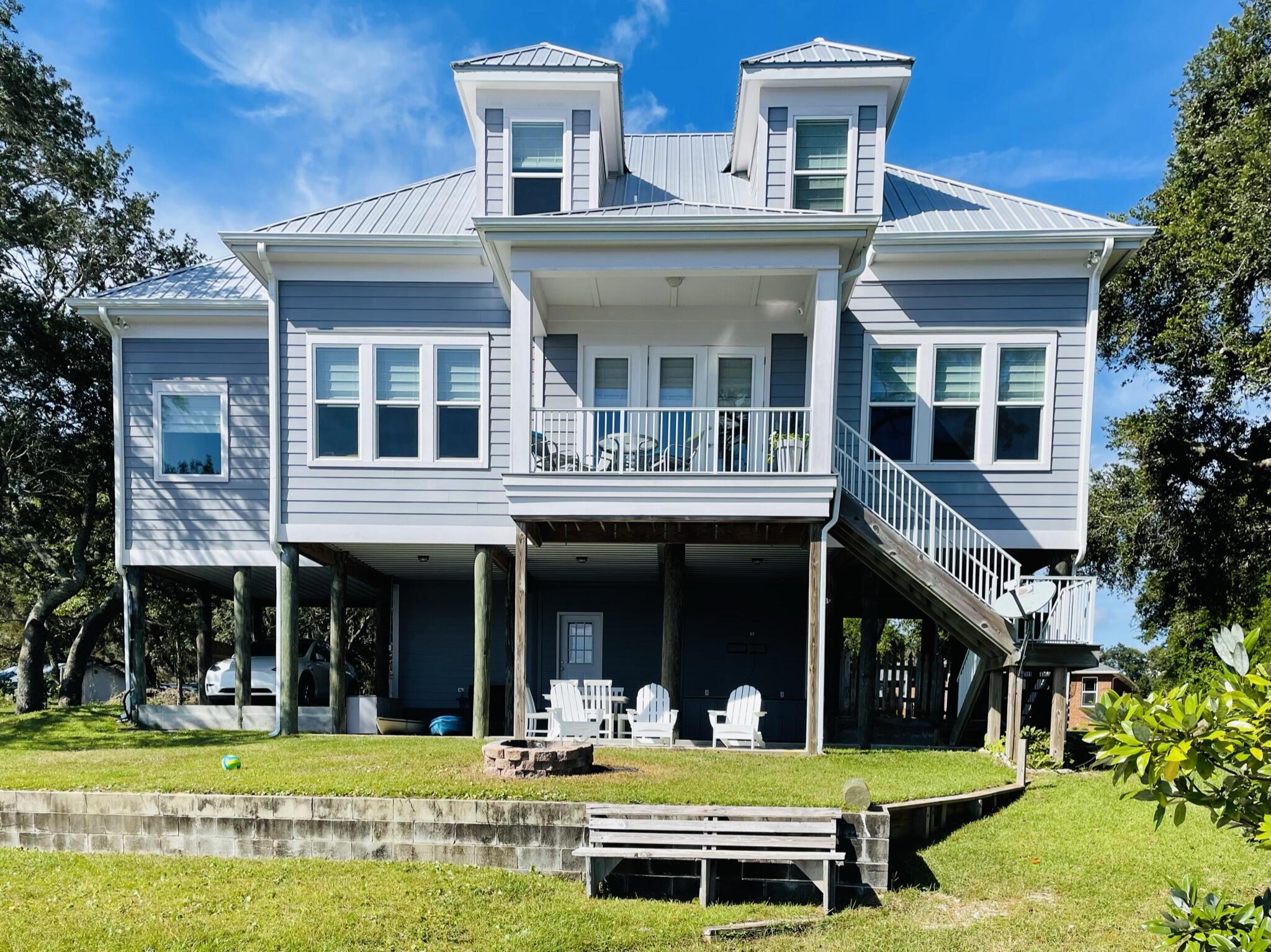 Welcome to 2975 Holley Point Rd in Navarre, FL, where coastal charm meets modern convenience. This lovely waterfront home spans 2,242 sf and offers quality craftsmanship combined with style and comfort. With 3 spacious bedrooms and 2.5 bathrooms, this residence is designed to meet the needs of today's discerning homeowner or investor.The raised design of the home provides an inviting entrance into a beautifully laid-out interior with sweeping bay views. The open floor plan seamlessly connects the living spaces, creating an ideal environment for both relaxation and entertaining. High ceilings and large windows allow stunning water views and natural light to fill the rooms, while highlighting the home's thoughtful finishes and details. The expansive living area flows into a well-appointed kitchen complete with ample counter space and cabinetry, making it a dream for those who love to cook and entertain. The primary suite offers a private retreat with a view including an en-suite bathroom with tiled walk in shower and soaking tub, plus a large walk in closet, providing a serene space with a view to unwind at the end of the day.
Outside enjoy a delightful constant breeze, large oak trees and a gently sloping lawn leading to a private dock with an 8000 lb. boat lift right on East Bay! Watch dolphins and ospreys, launch kayaks and paddleboards or fish for dinner from the dock of your private oasis. This is the best of FL waterfront living!
The ground level offers covered parking, a large storage room and an additional finished bonus space with full bath, currently used as extra sleeping room. There is room for a future elevator.
Situated in the desirable Holley Point area, this property promises a lifestyle of tranquility and convenience with easy access to the interstate and just a short distance from the stunning beaches of Navarre. This home would make a perfect primary residence, second home or vacation rental - the possibilities are endless.