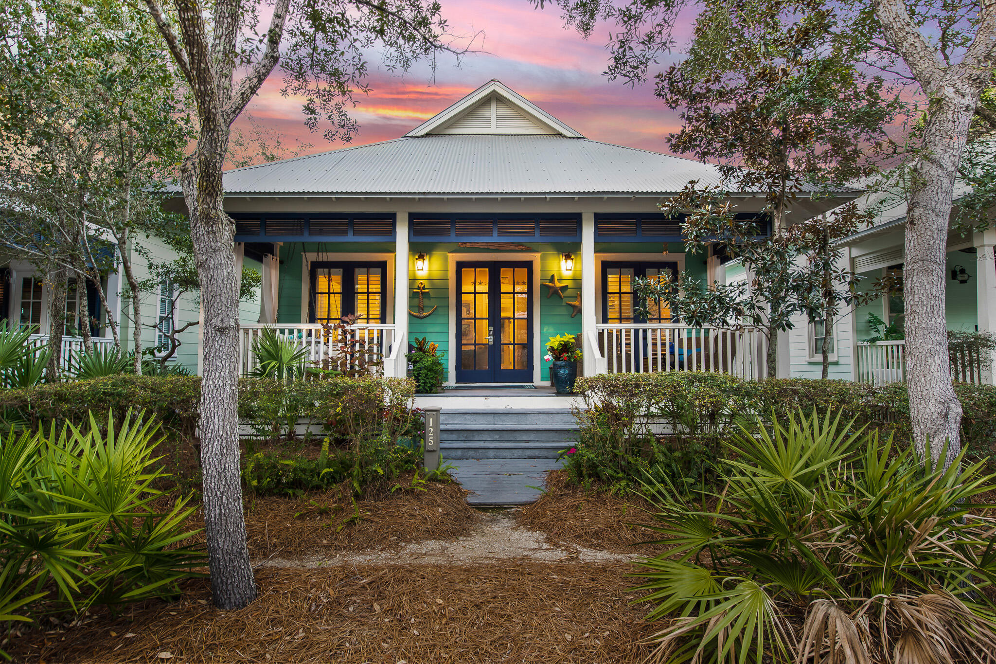 The sweetest Florida Cottage nestled in the sweet spot of the WaterColor community! This inviting 3BR/3BA home is located in the Rainbow Row section of Phase 1 just north of Seaside and only a short stroll to the beach, Town Center, Beach Club, and BoatHouse. A charming, covered front porch welcomes you into an open living and dining area that leads to a galley kitchen with stainless appliances and granite countertops, and three comfortably sized bedrooms. Warm toned hardwood floors complement cottage-style millwork including shiplap walls and extra wide trim. 10' ceilings throughout give an airy feel to the light-filled, cozy spaces that encourage gathering and relaxation. The master suite offers a beautiful ensuite with dual vanities, a separate tub, and walk-in shower along with French