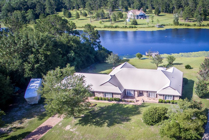 GOLD STAR PROPERTY! Gorgeous waterfront pool home! Within 30+/- minutes to the sandy white beaches of the Emerald Coast!! From first site you will love the details and upkeep of this beautiful home and landscaping.200+/- feet of waterfront on Lake Haven!You will be greeted with a resurfaced driveway, large attached 36x27 carport, and a screen-front option on the 2 car garage.Inside you will be delighted with the HI-MACS solid surface countertops, TWO master suites, and an open kitchen with breakfast room that overlooks the lake. Other features include:Accordion style storm shutters on all doors and windows, new gutters, salt water pool with new liner and sand filler, resurfaced pool deck and walkway, new dock with walkway, new gutters, new metal roof, 31x10 sunroom with pool and lake vie