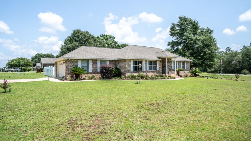 Take a look at this meticulously maintained, airy, fully bricked beauty. Corner lot with underground utilities, no detail overlooked. Extra concrete wraps around the home, and the yard welcomes with a full sprinkler system, lawn pump, and its own lamp post. Back yard features a brand new white vinyl fence. Enter through the covered front porch, glass storm door and custom stained front door. Large neutral tile, like new carpet, and upgraded fixtures throughout! The home boasts 8 high-end ceiling fans, matching drop chandeliers, trey ceilings, tilt-in vinyl sash windows, and lights in EVERY closet. Open kitchen/breakfast stuns with custom granite, 9 inch deep stainless sink, breakfast bar, pantry, and beautiful wood cabinetry. Large laundry with built in cabinets above.