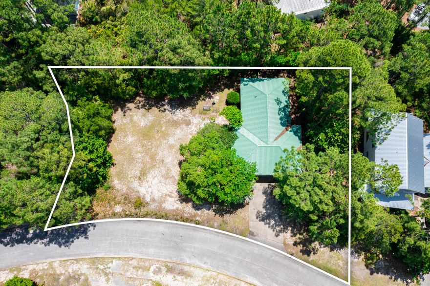 One-third acre lot with 180' of road frontage! Nestled in the heart of Old Seagrove just 1/2 mile from the Emerald Coast waters and white sugar sand beaches. This one-story home is situated on a LARGE lot! There is PLENTY of room to build your dream BEACH home and pool! Use the current home as a carriage house!!! Cozy one-story, 3/2 with open living area, 10' ceilings, tile floors throughout with concrete floors in the bedrooms and WRAP around porches. Greenwood Street public beach access is within a 1/2 mile. Easy bike ride or walk to the beach. Conveniently located within walking & biking distance to Seaside, Watercolor and our various restaurants & shopping on 30A. Buyer to verify all information and dimensions. Home sold unfurnished.