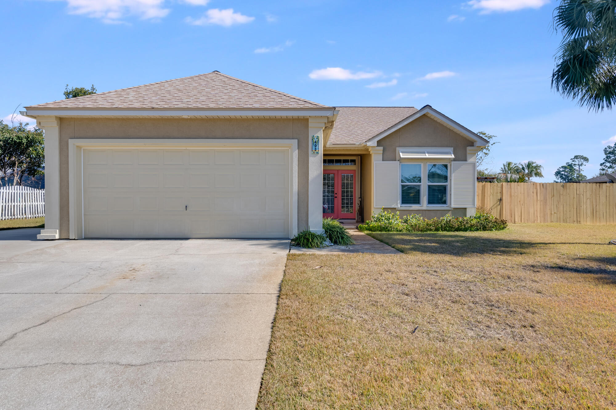 This immaculate well-maintained 3-bedroom, 2-bath home in Panama City Beach offers a perfect blend of comfort and style, on a spacious lot convenient to everything. The beautifully upgraded kitchen features new appliances, quartz countertops, and a stylish glass tile backsplash. Soaring 12-ft ceilings with crown molding enhance the great room's open feel and ventless gas fireplace adds the right amount of warmth.  Desirable split-bedroom floor plan provides privacy and functionality with the primary bedroom located at back of the home. Large walk in closet and stylish barn doors lead to the updated primary bath featuring dual vanity with quartz tops and separate water closet. French doors lead to a screened-in patio, overlooking a large backyard with ample space for a poo