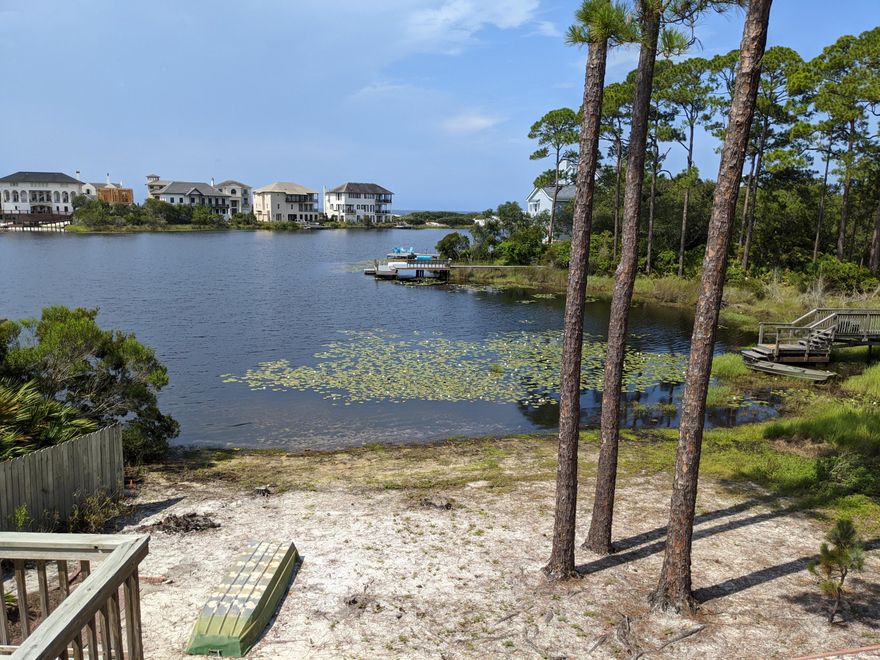 Beautiful property with 100 ' of lake frontage on picturesque Lake Stallworth. Cozy beach cottage has fantastic views with kayaking, canoeing, fishing and swimming right out the front door. High ceiling in the great room gives a spacious feeling for relaxing and taking in the scenery.  Master bedroom has private deck while the inviting large outside deck looks out over the lake and dunes on the south side of the house. Mature trees and landscaping helps add privacy. Home is being sold partially furnished and has been very well maintained.