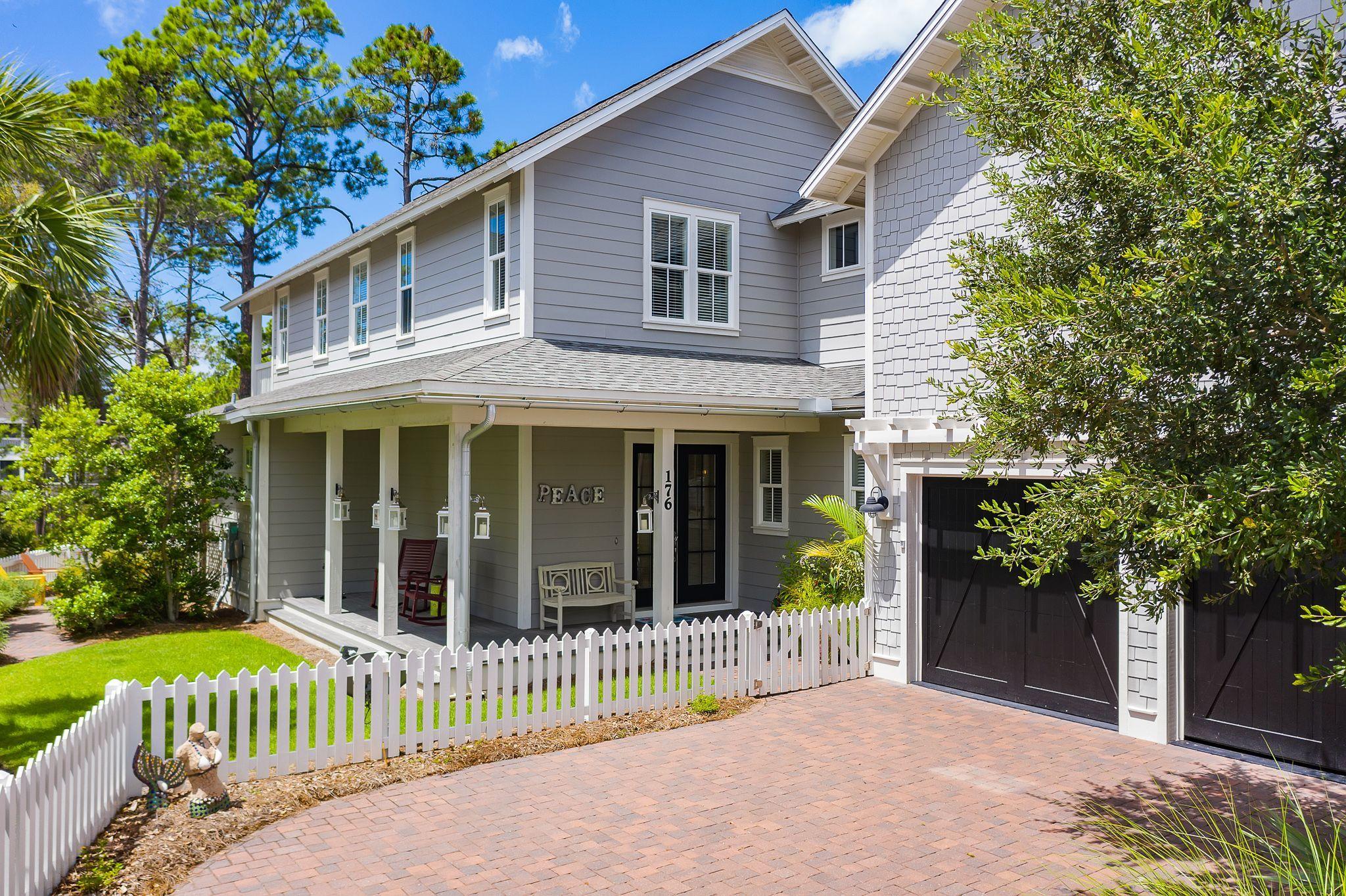 This 4 bedroom, 4 1/2 bath home located in the gated community of Watersound West Beach is the beach home you have been looking for. This home offers a coveted 2 car garage and ample parking in the driveway and is a short walk to the neighborhood pool and boardwalk to the beach. The open floor plan is great for entertaining or family gatherings. The kitchen offers an oversize island finished with a brown - golden agate countertop. This exclusive slab surface is very unique in semi precious gemstone agate. The kitchen has ample cupboard space, a large pantry under the stairs, stainless GE appliances to include a gas range and stainless steel range hood. The home offers wood flooring throughout along with white shiplap walls. The home also offers a wet bar with a stainless steel beverage