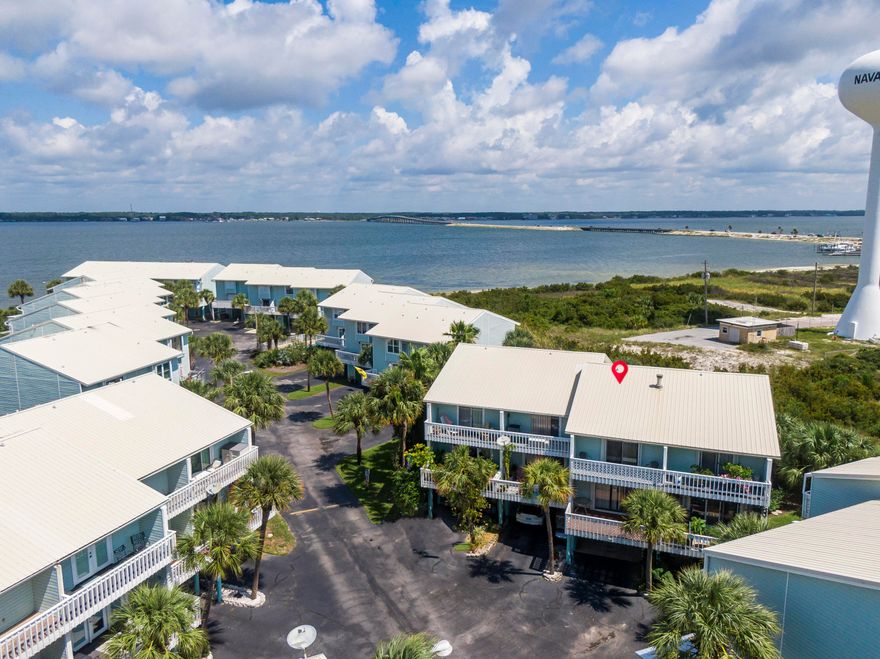 WATERVIEWS from this Spacious 2 Bedroom, 2 Full Bathroom, 1294 Sq Ft Townhome, with Three Balconies, located in the Highly Desired Santa Rosa Soundfront Sandcastle Community. Great Potential! Update it and apply your Creative Touch to make this the Perfect Beach Home. Sandcastle Community has a large In-Ground Pool and it's own Private Beach with Dock/Fishing Pier and First Come, First Serve Boat Slips included in the Low HOA Fees. Entryway Steps have a Stair Lift & Railing for Wheelchair Accessible and the Home is Equipped with Installed Accordion Hurricane Shutters on all the Windows & Sliding Doors. The 3rd Floor Guest Bedroom and Balcony outside the Kitchen have Sound Water Views, and there's two additional Balconies for Relaxing and Entertaining... ...The Location is Perfect to Enjoy so much of Navarre Beach's Leisure and Water Activities, being Close to All the Restaurants, Pier, and Entertainment, as well as the Great Convenience of living in a Sound Front Community with Private Beach and Pier, providing ease of Fishing, Kayaking, Paddleboarding, Boating, and more! 

The Gulf of Mexico's White Sands and Emerald Hued Waters are a short distance away, where you can Sunbathe, Swim, Enjoy Peacefulness of the Ocean and Birds, or Hike over to Florida's Longest Fishing Pier and Cast out for some King Mackerel, Redfish, etc..,  Navarre Beach is the "Florida's Most Relaxing Place" where you can enjoy Hiking & Biking, Parks, Recreation, and Entertainment Nearby. Additionally, on the West End of Navarre Beach, is the Gulf Islands National Seashore that has Miles and Miles of unfettered White Sandy Beaches and in the Top 10 most Visited National Park Service sites in the entire Nation!