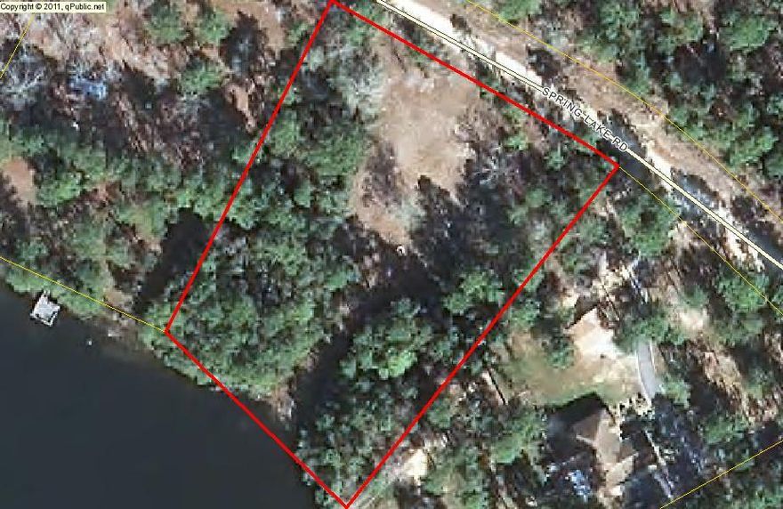 BEAUTIFUL WATERFRONT LOT ON SPRING LAKE! Sunrise or sunset for your own porch... watch the wildlife play... listen to the birds... Peaceful Paradise! Lot gently slopes to the water and has been partially cleared by current owner. There are some large oaks on the lot and the view of the lake is awesome! The subdivision is restricted against mobile homes and rentals to guarantee the security of your investment. The water tap has been paid for and is on the lot, electricity is available also but not in place. There is a common area for all homeowners of the subdivision that provides a boat launch, gazebo, and restrooms. Do not let this opportunity pass you by! (All pertinent information should be verified by the buyer/agent.)