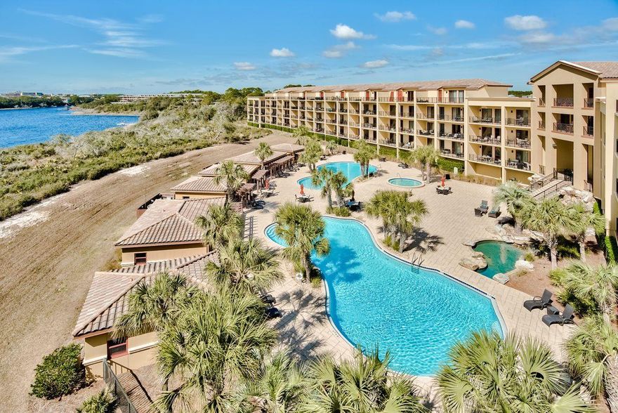 Location and views are pronounced at this elegant four bedroom condominium home that presides over stunning gulf and lake vistas. Arranged over two floors, this prime vacation home/full-time residence promises a quiet resort lifestyle chilling on Blue Mountain Beach, socializing with friends, and perhaps a few rounds of golf at Santa Rosa Golf Club. Ten foot ceilings trimmed with crown molding and gleaming travertine flooring provides a smooth transition between capacious living spaces. Sliding doors provide lake and Gulf views, even when relaxing by the fire. The kitchen boasts custom birchwood cabinetry with Viking appliances and granite-topped island. Generously proportioned rooms are matched by deep terraces for al fresco living with magnificent lake views. This upscale property is all about living life to the full including three pools with cascades, two hot tubs, a fitness center and private theater room. Cast a line in the rare coastal dune lake (Big Redfish Lake), go boating or enjoy hiking and biking in neighboring Grayton Beach State Park. It all starts here.

