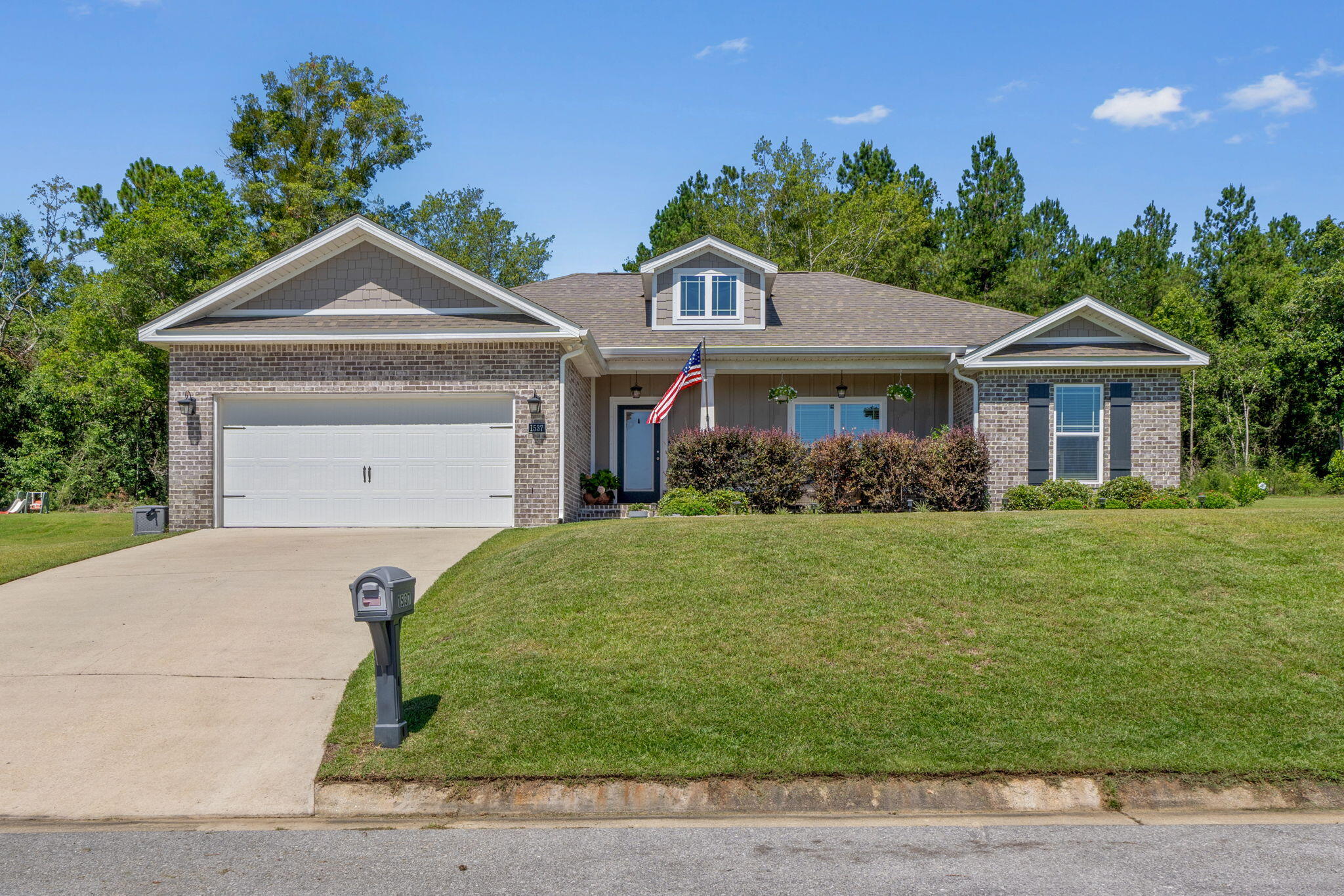 Beautiful newer home! Spacious 3-bedroom 2-bathroom home with plenty of style! From the granite countertops, modern fixtures to the high trey ceilings, this gorgeous home feels like luxury living! The covered front porch is perfect for enjoying that morning coffee or watching the sunsets. The large entryway opens up to the spacious kitchen and living room. The luxury vinyl plank and carpet flooring flow nicely throughout the main living areas. The dining area has a stunning light fixture and is perfect for hosting large gatherings. The master bedroom suite has a large bathroom with double vanity, walk-in closets, large custom tiled shower with a rain head and separate garden tub. The two guest bedrooms and full bathroom are on the other end of the home for complete privacy. Right off the kitchen you will step out onto a beautiful covered lanai porch great for grilling out or entertaining with friends! The spacious laundry room is very functional and the home backs up to a wooded area providing extra privacy. Come make this your new home!