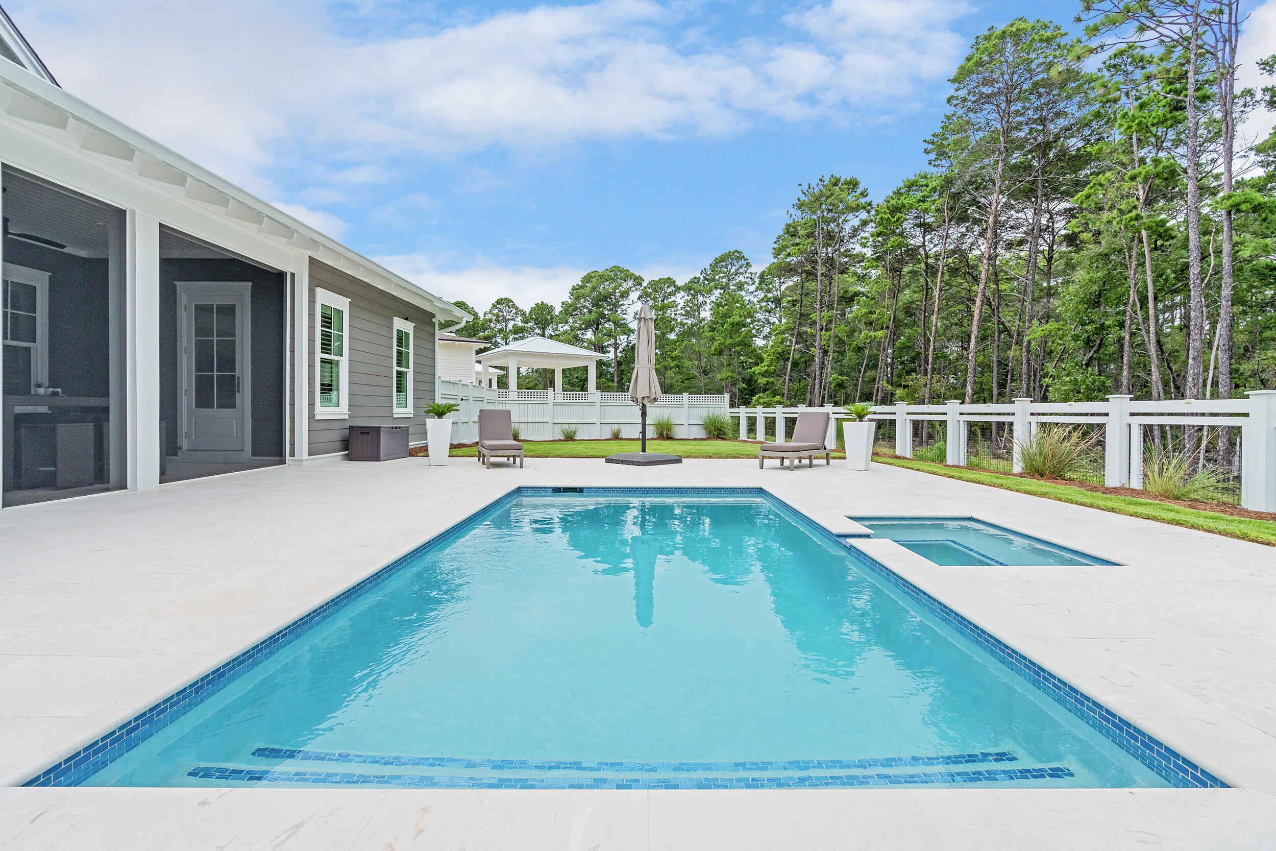 SELLER OFFERING INTEREST RATE BUY DOWN AT 4.4%! PLEASE CALL FOR DETAILS! WHY WAIT OVER A YEAR FOR A NEW BUILD AND PAY $150,000 - $200,000 MORE WHEN YOU CAN HAVE THIS GORGEOUS LIKE-NEW HOME NOW FOR MUCH LESS? This stunning newly built home is the ONLY Romair built home on the market with the highly sought-after Duxbury plan with the 2024-2025 high-end cabinetry, countertops, tile and fixtures upgrades throughout. And here is the best part, it is like-new and priced $150,000 - $200,000 less than recent comparable sales with the same builder, same plan, same street, all within 90 days (ask us for the details). As a bonus and also included is a 1 year home warranty! The must-see feature of this home is the premium lot with a huge backyard oasis (largest yard in the neighborhood) backing up to a nature preserve with a breathtaking salt water heated pool and spa, cabana, outdoor wood burning fireplace, large screened in patio and privacy fence around the entire back yard.
This masterpiece is a stunning and unique single level home offering four bedrooms, five bathrooms, plus an office/workout room, providing ample space for your family, work, and relaxation needs.
The highly desirable upgrades in this home include:
Premium lot with oversized backyard backing up to nature preserve
Saltwater heated pool with spa
Cabana with outdoor fireplace and gas grill
Screened in back patio
Plantation shutters and curtains throughout
Upgraded white oak cabinets throughout
Upgraded lighting package
Heated and cooled garage
Outdoor lighting in front and backyard
Extended driveway and parking pad
Irrigation system filter
Surge protector built into electrical system
This home is less than 1 year old and is better than new with the upgrades and is in immaculate condition. As you step inside, you'll be greeted by the 10-foot ceilings with 8-foot solid core doors and a seamless flow from the living area to the kitchen and dining space, perfect for entertaining and everyday living.
The attention to detail is evident in every corner of this home with strategically placed bedrooms throughout the home, offering privacy and tranquility. The kitchen is a chef's dream, featuring quartz countertops that add a touch of elegance and durability. The 36-inch dual fuel range, 36-inch French door cabinet panel refrigerator with bottom freezer, and cabinet panel dishwasher appliances by GE Monogram make cooking and entertaining a breeze.
Throughout the home, you will find many luxurious upgrades including the custom-designed cabinetry with a contemporary overlay and soft-close drawers and doors, designer-curated porcelain tile in all bathrooms with quartz countertops in the kitchen, bathroom and laundry room, and under cabinet lighting all add a luxurious touch. Enjoy the convenience of a single level living, where everything is easily accessible and there are no stairs to navigate. This makes the home suitable for all ages and abilities. The 2-car detached garage is conveniently located within close proximity to the laundry/mud room and separate from the main living area.
The Watersound Origins community is one of South Walton's most coveted neighborhoods for its exceptional amenities, beautiful new homes, and prime location. Amenities include the Village Commons pool & fitness center, sports courts including tennis and pickle ball, miles of nature trails, dock access to Lake Powell, unlimited golf, and lots of green space for outdoor play. The all new Watersound Town Center brings a new level of excitement and convenience to the community with a Publix Super Market, delicious restaurants, healthcare facilities, a seasonal weekly Farmers Market, and more right at the entrance to the neighborhood!
VIDEO AVAILABLE UPON REQUEST!