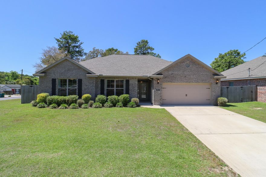 Welcome to 59A 7th Street in Shalimar, Florida -- a meticulously maintained, single-story brick home completed in December of 2019, and situated on a corner lot with no HOA! This 4-bed, 2-bath home offers a thoughtful layout with a pass-through laundry room, spacious two-car garage, and numerous upgrades. The kitchen, which opens to both the dining and living area, features granite countertops, soft-close cabinetry, stainless steel appliances, and a bar-height seating area. The primary suite includes a tray ceiling, walk-in closet, double vanity, soaking tub, and walk-in shower. Outside, enjoy a covered back patio with a paver grilling area and a fully fenced yard with an 8-foot privacy fence along the rear. Additional highlights include hurricane-rated fabric shutters, a Rain Bird sprinkler system, Pentair Sta-Rite well, and a Lennox HVAC system. This move-in-ready home offers the perfect balance of comfort, functionality, and location in a centrally located area of the Florida Panhandle!