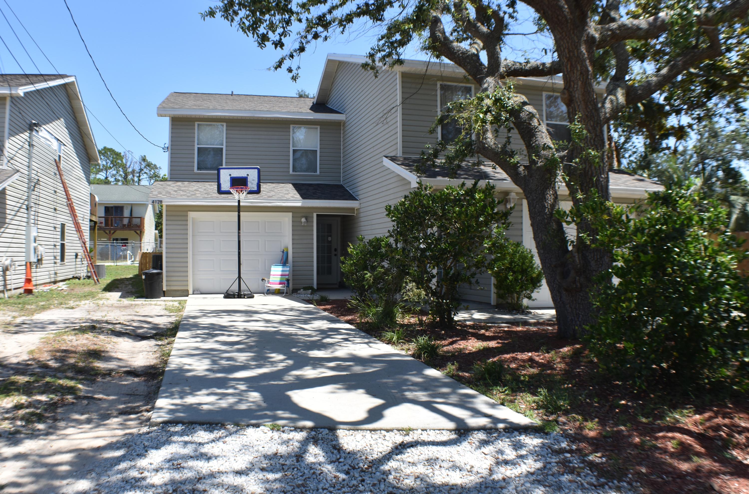 Brand new roof and AC system for this 3BR/2BA townhome! The home features a split-bedroom floor plan, wood laminate flooring, a covered patio downstairs and an open deck upstairs, and a fenced backyard with a shed. The garage was converted into a 4th bedroom/bonus room, however, you could easily remove the wall and turn it back into a garage. There is a community pool right in the middle of the common area so it's just steps from the home. You'd also have access the Waterhaven Community Boat Ramp on St. Andrew's Bay which is just around the corner. This is a move-in ready home in a quiet neighborhood near golf courses, shopping centers, schools, the Navy base and of course, the beach! All info is approx. and must be verified by Buyers if important. Seller is licensed FL REALTOR
