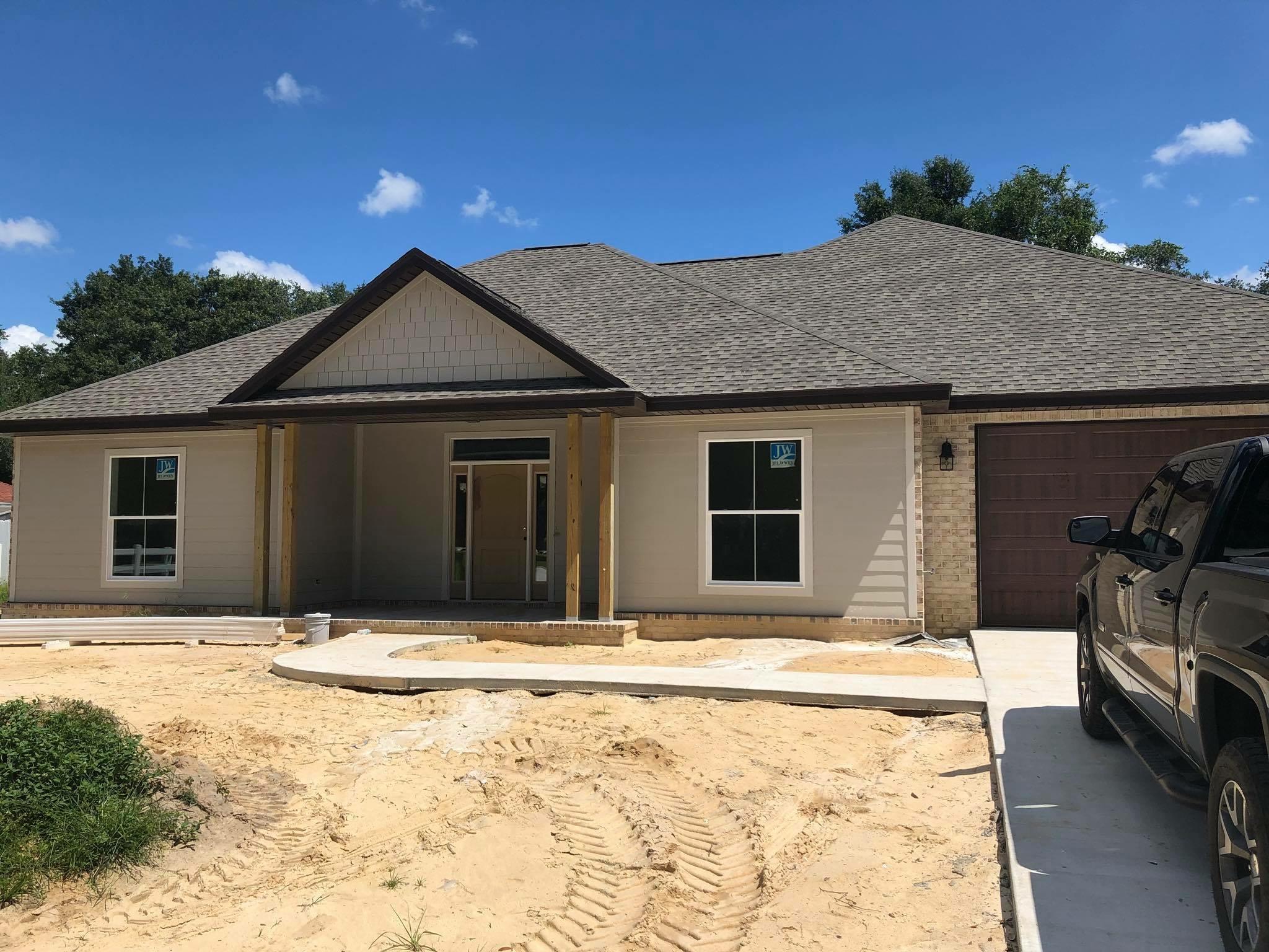 Totally custom home SOUTH of I10 on a FLAT, nearly .4 acre lot. Excellent location in an established community. This size lot and location are hard to find. Four bedrooms, all with walk-in closets, and three FULL baths. ALL the upgrades you can imagine in this home, built by local award winning custom builder. Spacious open floor plan with custom wood coffered ceiling in living area. 8'' wood plank porcelain tile throughout living area. Custom cabinets with BUILT-IN range hood in kitchen with GE upgraded stainless appliances and gas cooktop. Granite countertops with huge island and large walk-in pantry. In addition to the four bedrooms there is also a large flex room, suitable for an office or playroom. Crown molding in living areas, flex room, and throughout master suite and bath.