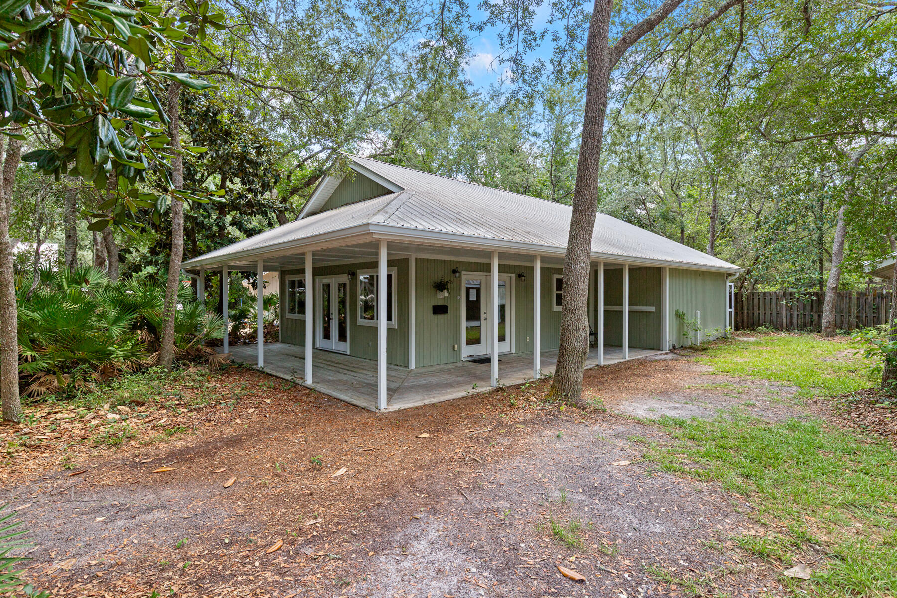 Point Washington Estate sized lot over 1 Acre! Established natural buffered perimeter and south fence. MIXED USE, RESIDENTIAL AND/OR COMMERICAL. So close to Grayton Beach and the 15 restaurants there yet so secluded. 2 bedrooms 1 full bath with a new AC (Nov 2024). Spacious living area and a front porch with a cozy back porch. Huge fenced inground pool for parties! Front building with half bath used as an office. AC replaced Apr 2022. Stand-alone storage building. Covered parking attached to the pool storage. Concrete pad originally used as a TENNIS/BASKETBALL COURT. Could be refurbished or converted to pickleball courts or the foundation for a new home with views of the Choctawhatchee Bay. Sold AS IS and all measurements are estimates, buyer to verify.