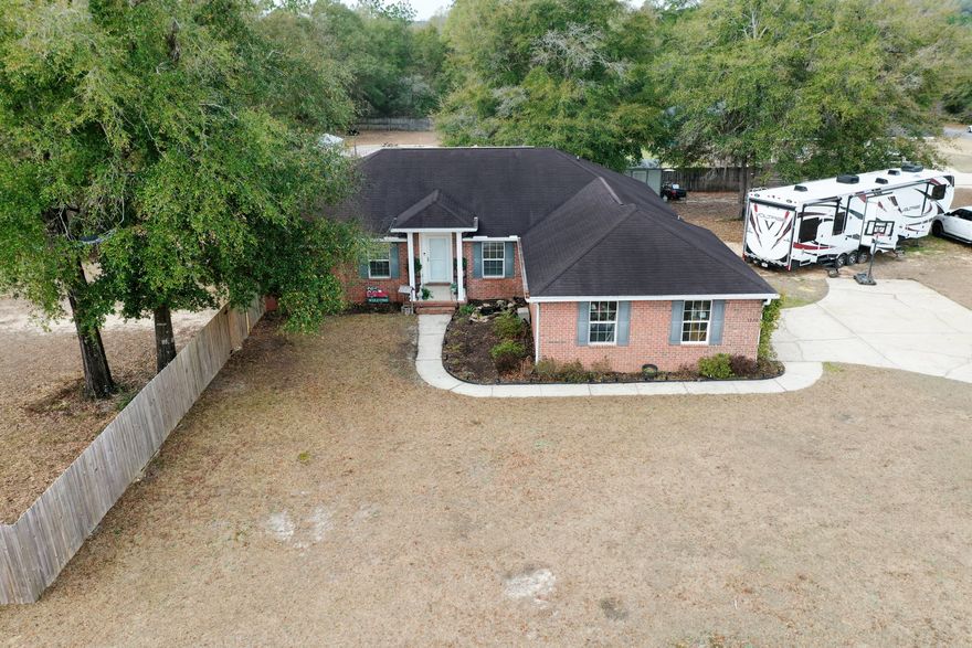 Charming Southern 4-bedroom, 2-bath home with dedicated office and a true country-living feel! Nestled on a full acre.  NEW ROOF (dimensional shingle) exotic black to be installed March 7th.  You'll absolutely love this open living/dining area concept, that flows seamlessly into the kitchen, which boasts custom white cabinets with new hardware, new granite countertops, custom tongue and groove installed on back of the bar 2026, ceramic farm sink, refrigerator 2025, and dishwasher in 2024. Allergies, don't worry! Premium LVP flooring was installed throughout the home in 2022.  Enjoy peaceful surroundings, comfortable living spaces and the perfect blend of charm and functionality. Never worry about power loss for any reason!  Top Brand Generac Full House generator was installed in 2023. This split floor plan provides plenty of windows, bringing in natural lightning to all the rooms.  The master suite provides a luxurious retreat, large enough for a small sitting area and you'll enjoy the new rustic accent wall. The Master Bath Suite boast dual vanities, a separate tub, separate shower and his and hers walk-in-closets.  Thoughtful details abound, laundry room with cabinets, LED lights, and the flooring is a premium 12inch LVP. Outside is your personal oasis, boasting a covered patio with a new 80inch ceiling fan, extra patio pad poured the length of the house in 2025, premium finishes, the entire back yard is privacy fenced with several gates, including a triple medal gate, powered chicken coop and an expansive covered run designed for both chickens and turkeys.  Both currently reside at this beautiful home.  The seller made sure travelers and campers are taken care of, he added a 50V AMP to provide full function for any RV. The driveway can easily hold 8 vehicles and there's plenty of room for a boat as well.  Summer is around the corner, don't worry, an above ground pool was placed into the ground for easy entrance and exit. If you like having a small garden, then you're ready to start planting with three custom raised garden beds. This home has everything and is perfect for family gatherings.  If you hurry, the seller might leave you a turkey and a few chickens.  Call today, this home won't last long!    