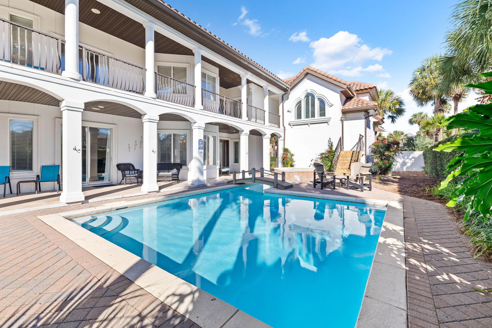 48 Tranquility Lane is an exceptional coastal retreat offering 5 bedrooms, 3.5 bathrooms, and over 3,400 square feet of thoughtfully designed living space, making it perfect for families and guests to enjoy. This stunning property features one of the most impressive private pools in the area, complete with a spillover spa, a picturesque footbridge, and a 6-foot privacy fence, ensuring a secluded outdoor oasis like no other. Recent updates, including new hardwood flooring, fresh paint, modernized mattresses, and a high-efficiency pool heater, further enhance its luxury and comfort. This home has $155,000 + booked in 2024 with rental income ranging from $150K-225k annually in gross rental history. The first floor showcases an open-concept layout with a chef's kitchen featuring exotic granite countertops, flowing seamlessly into a spacious living room complete with a flat-screen TV and fireplace. The dining area overlooks the private courtyard and pool, creating an ideal setting for entertaining or relaxing. This level also includes a laundry room, a bedroom with full-size bunk beds, and a half bathroom. On the second floor, two expansive primary suites await, each with king-sized beds and private ensuite bathrooms. The primary suite above the garage also includes a cozy sitting area with a sectional and a queen sofa sleeper. Two additional bedrooms, one with two queen beds and another with a king bed, provide ample and flexible accommodations.

Professionally decorated with custom furnishings and meticulous attention to detail, the home exudes sophistication. High-speed internet ensures seamless connectivity, while an additional refrigerator in the garage adds practicality. Outside, the home's extensive living spaces and extraordinary pool area offer endless opportunities for relaxation and entertainment. Situated just across the street from the beach and a short distance from Club Destiny, the property provides access to a wealth of community amenities, including a state-of-the-art clubhouse, fitness center, seasonally-heated swimming pool, tennis and basketball courts, a putting green, a children's playground, and even a private 25-seat IMAX theater.

Located in one of the most sought-after neighborhoods, 48 Tranquility Lane combines luxury, privacy, and convenience. Whether lounging in the secluded courtyard, enjoying the nearby white-sand beaches, or exploring the exceptional amenities of the area, this home offers the ultimate coastal lifestyle.

Contact us today for rental projections & cost-to-own figures.