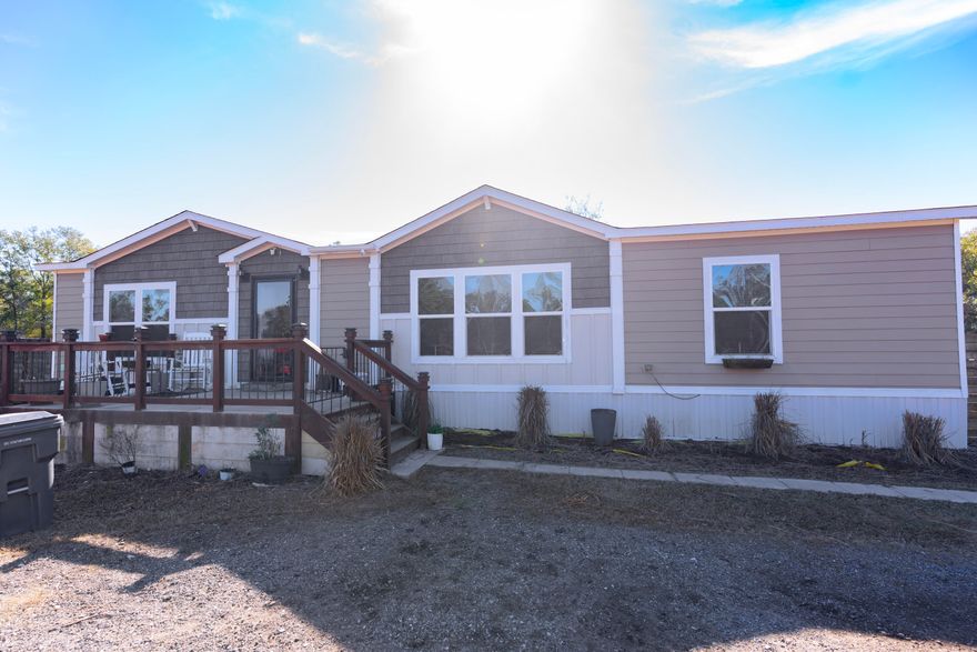 Welcome to this beautifully maintained one-owner, 3-bedroom, 2 bath, double-wide manufactured home, sets on a spacious one-acre lot.  This property offers room to breathe, garden, and peaceful farm living while still being close to town conveniences.  Inside, you will find a well-appointed kitchen with ample cabinetry, and a comfortable primary suite with a large bathroom and walk-in closet.  The home features numerous extras, making it both functional and inviting. You'll love the mature fruit trees lining the perimeter, providing shade and seasonal harvests.  The property also includes a 2-car covered parking space with space for a small workshop/storage.  There is also a play house for the little ones! Enjoy fresh eggs from your very own chickens. Home may also be sold separately for $165,000.  If the buyer doesn't want to move the home at the time of purchase, they have the option to lease the land from the seller at monthly lot fee of $500.


