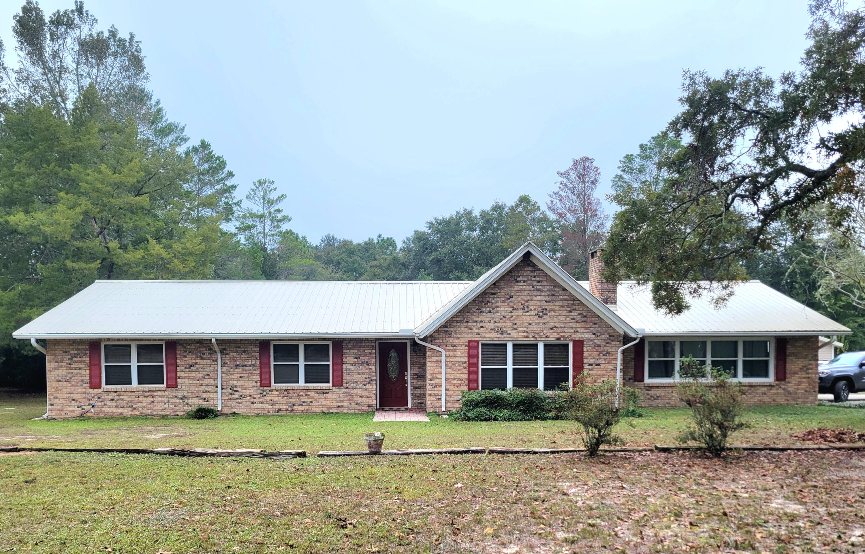 Live ''big'' in this 2364 s.f. ranch style brick home on 1.55 acres, with a metal roof.  Complete with a 10' deep inground pool with new 10 yr. liner AND 1 bedroom guest-pool house with bath and kitchenette.  Plenty of storage with the double car garage and yard building for lawn and pool equipment Home has ribbed Cathedral ceilings in  living and dining room in addition to the large brick wall fireplace and hearth has door beside it for the wood that can be loaded from an access area in the garage. Natural oak flooring and ceramic tile.  Master bedroom has super large walk-in closet. Put this one on your list!