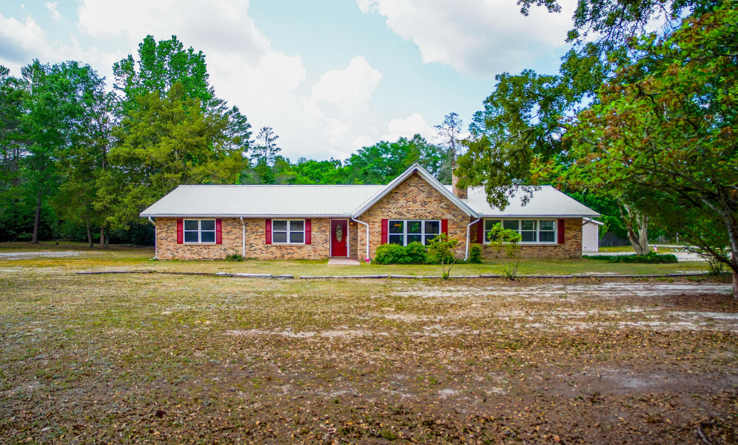 Dream home come true with this beautiful ranch style brick home with 2364 s.f. on 1.55 acres. Home has all new appliances in 2023 including the washer/dryer. Cathedral ceilings in great room with large brick hearth and wood burning fireplace, natural oak flooring and new ceramic tile. Large Master bedroom w/ super large walk-in closet, spacious master bath with double sink vanity and double door shower. For entertaining backyard has beautiful deck and a 10' deep inground pool, with a new liner in 2023 with a 10 yr. warranty. Also a 1 bedroom, 1 bath Guesthouse. Additional storage with the double car garage and yard building for lawn and pool equipment. Metal roof installed in 2016. Seller will consider a credit at closing towards a new HVAC system OF $6,000 w/ full price offer Tile floors were installed in 2023.